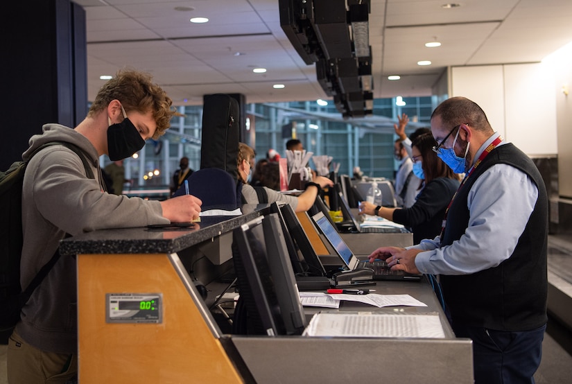 Passengers check in for their flights.