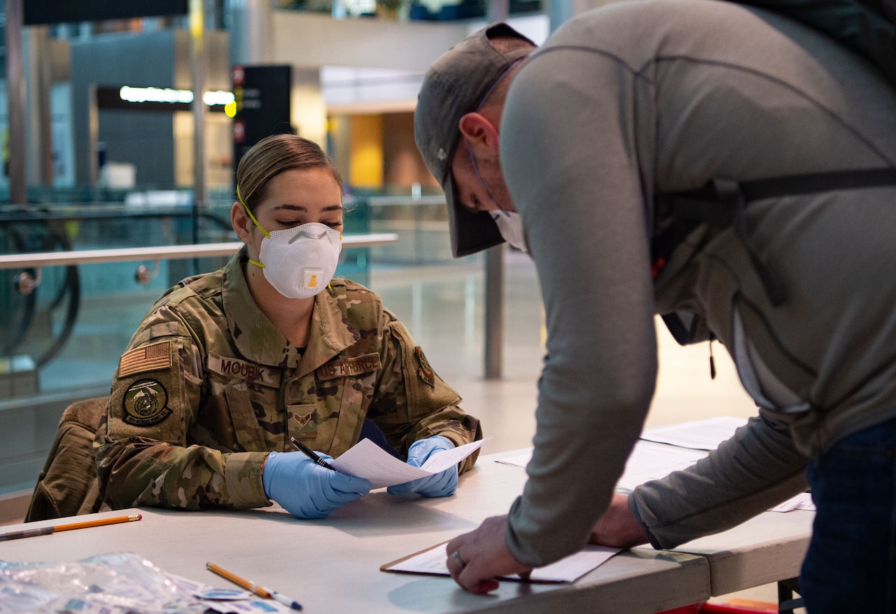 An airman checks medical questionnaire paperwork.