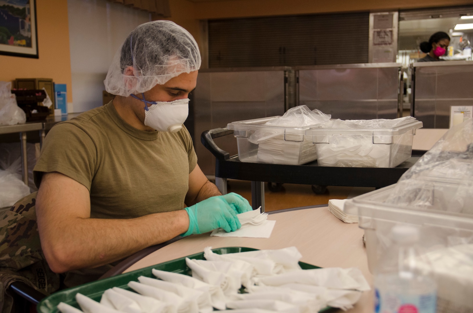 U.S. Army Spc. David Siegel, an infantryman with Charlie Company, 2nd Battalion, 113th Infantry Regiment, New Jersey Army National Guard, prepares utensils for residents at the New Jersey Veterans Home at Paramus in Paramus, N.J., May 1, 2020. More than 120 New Jersey National Guard Soldiers and Airmen are assisting the home’s staff in caring for the residents during the COVID-19 crisis.