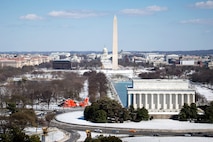 A Coast Guard MH-65 Dolphin helicopter crew from Air Station Atlantic City flies past the Lincoln Memorial and Washington Monument during a patrol in Washington D.C., March 16, 2017.