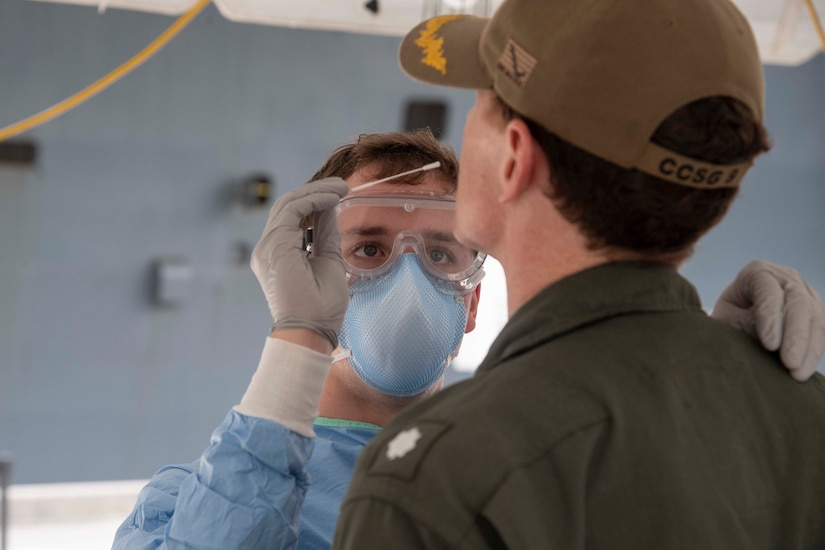 A sailor takes a COVID-19 sample for testing.