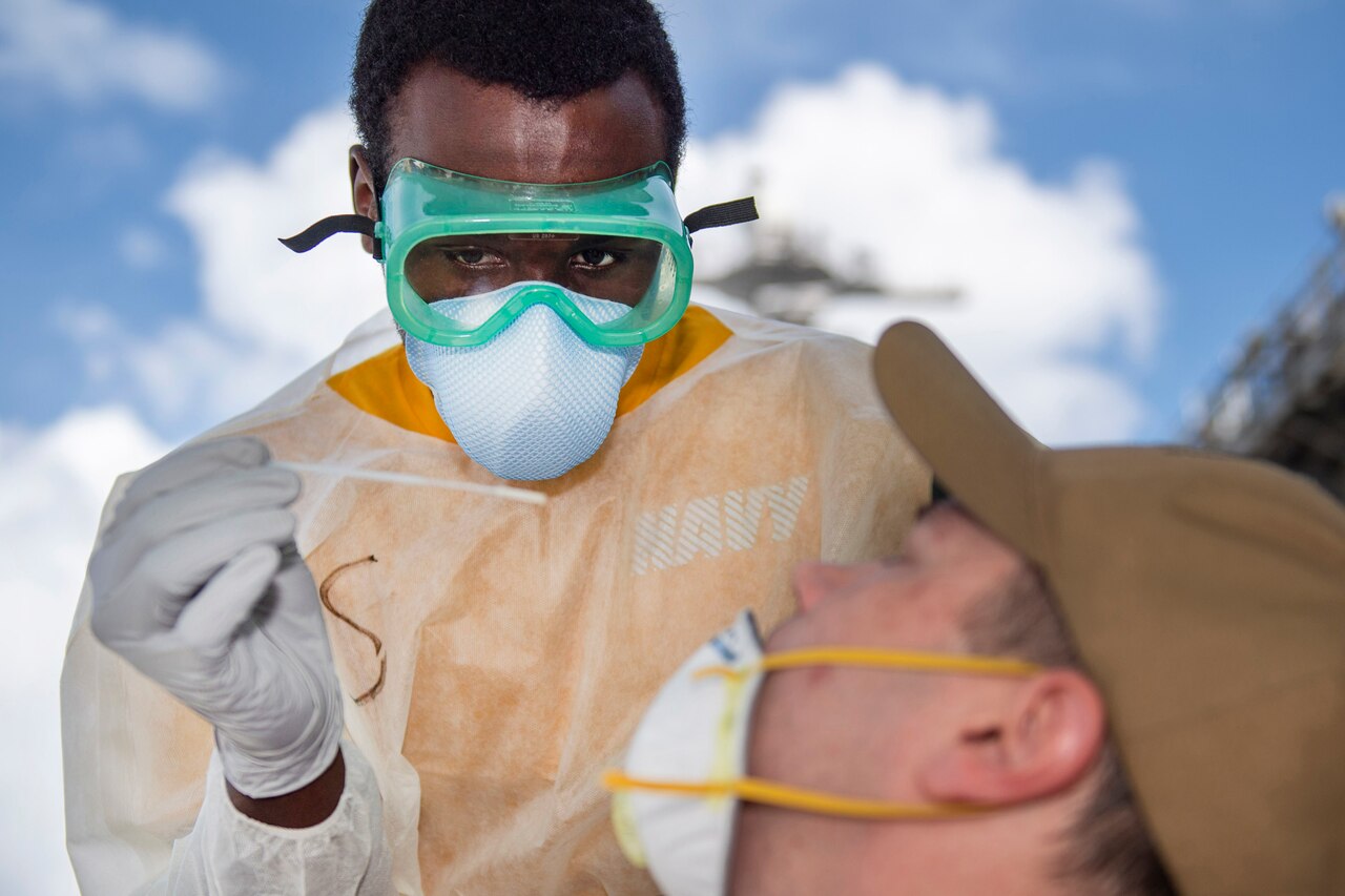 A sailor takes a nasal sample.