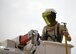 Photo of a electrical systems shop Airman stands in a truck manlift before performing emergency maintenance on an electric pole