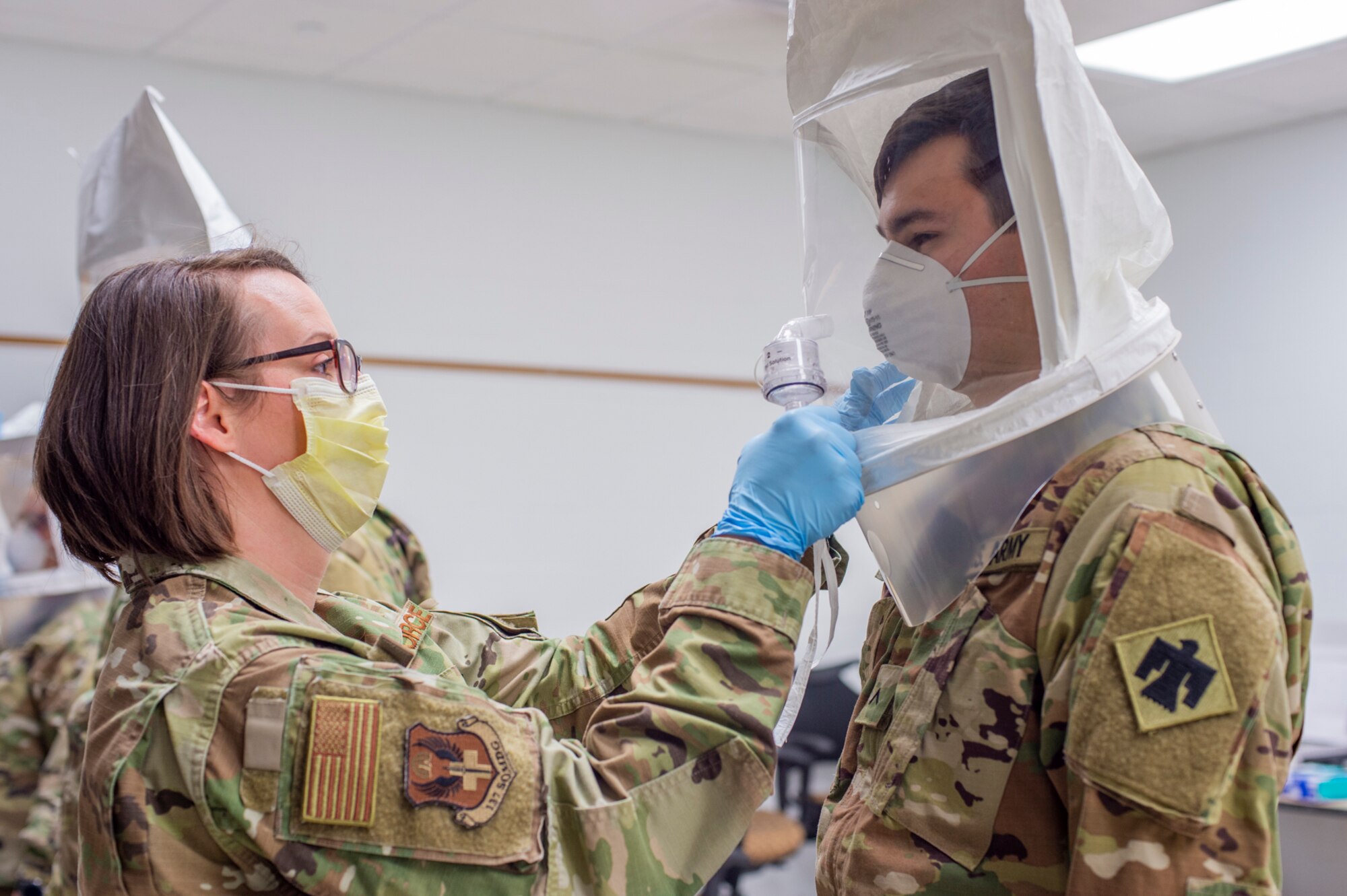 Tech. Sgt. Rebecca Keylon, a bio-environmental engineering technician with the 137th Special Operations Medical Group, Oklahoma Air National Guard, administers a N95 medical mask fit test to Oklahoma Army National Guard Pvt. Connor Boal, a medic with the Oklahoma Army National Guard Medical Detachment, as part of COVID-19 medical response training at the 90th Troop Command Headquarters in Oklahoma City, April 10 - 11. The training, which included presentations by the University of Oklahoma Medical Center and the Oklahoma County Health Department, will prepare Oklahoma Army and Air National Guard medical personnel for potential missions with their civilian counterparts in response to the outbreak of COVID-19 across the state. (Oklahoma National Guard photo by Staff Sgt. Brian Schroeder)