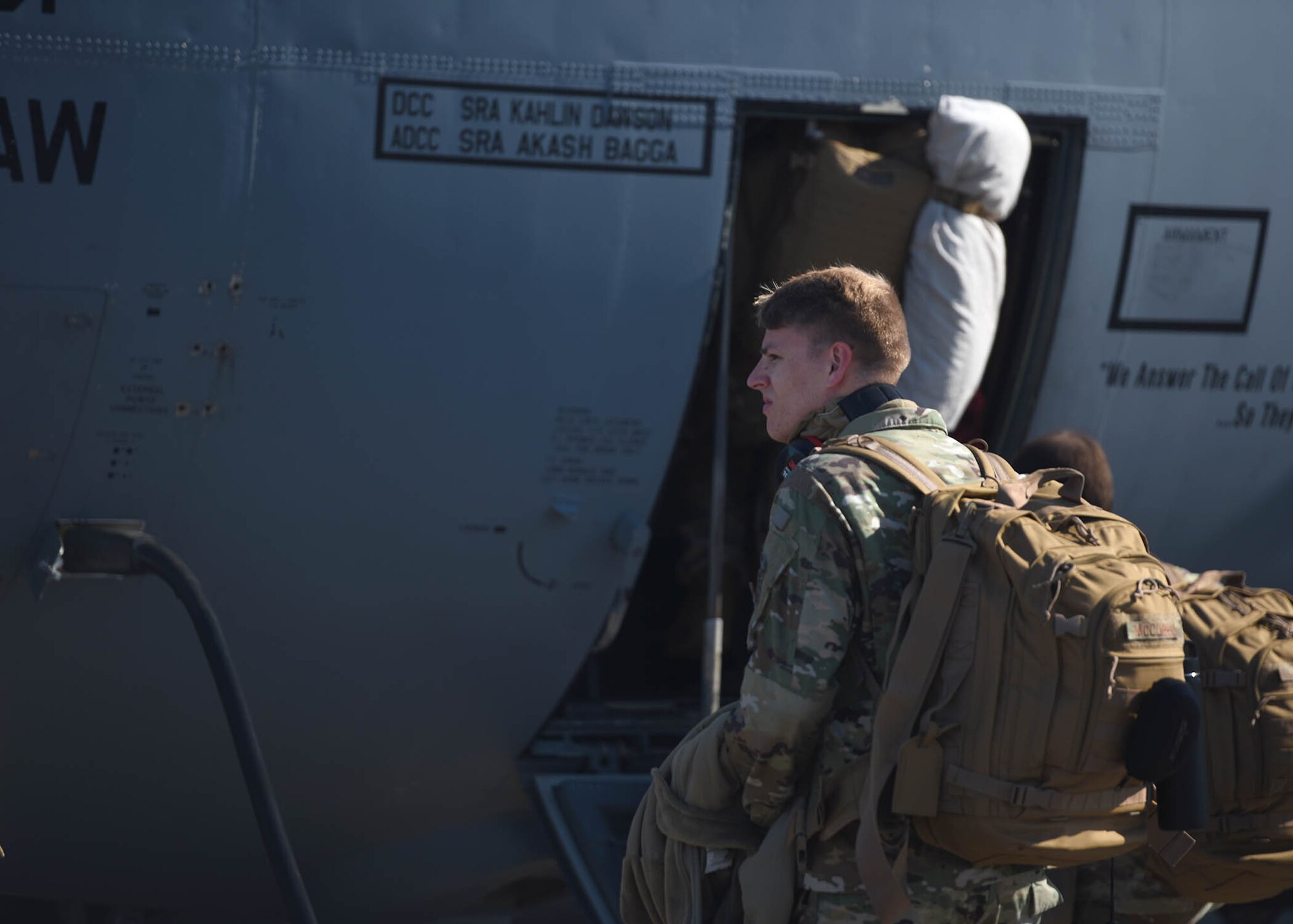 Airmen sit on the ramp of an aircraft before take off