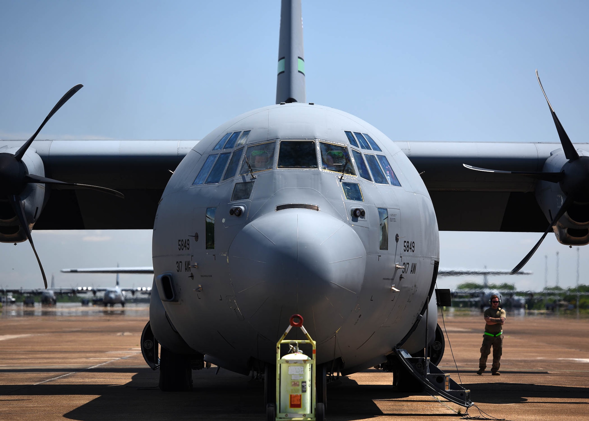 Airmen gather arounf an aircraft before take off