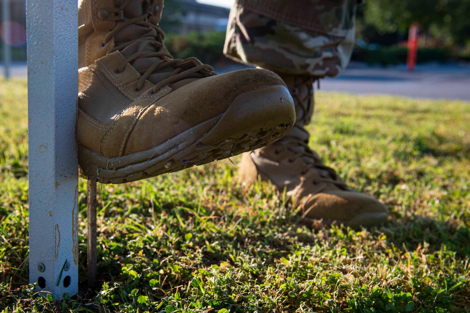 Photo of an Airman securing a tent for a COVID-19 Tier 2 screening.