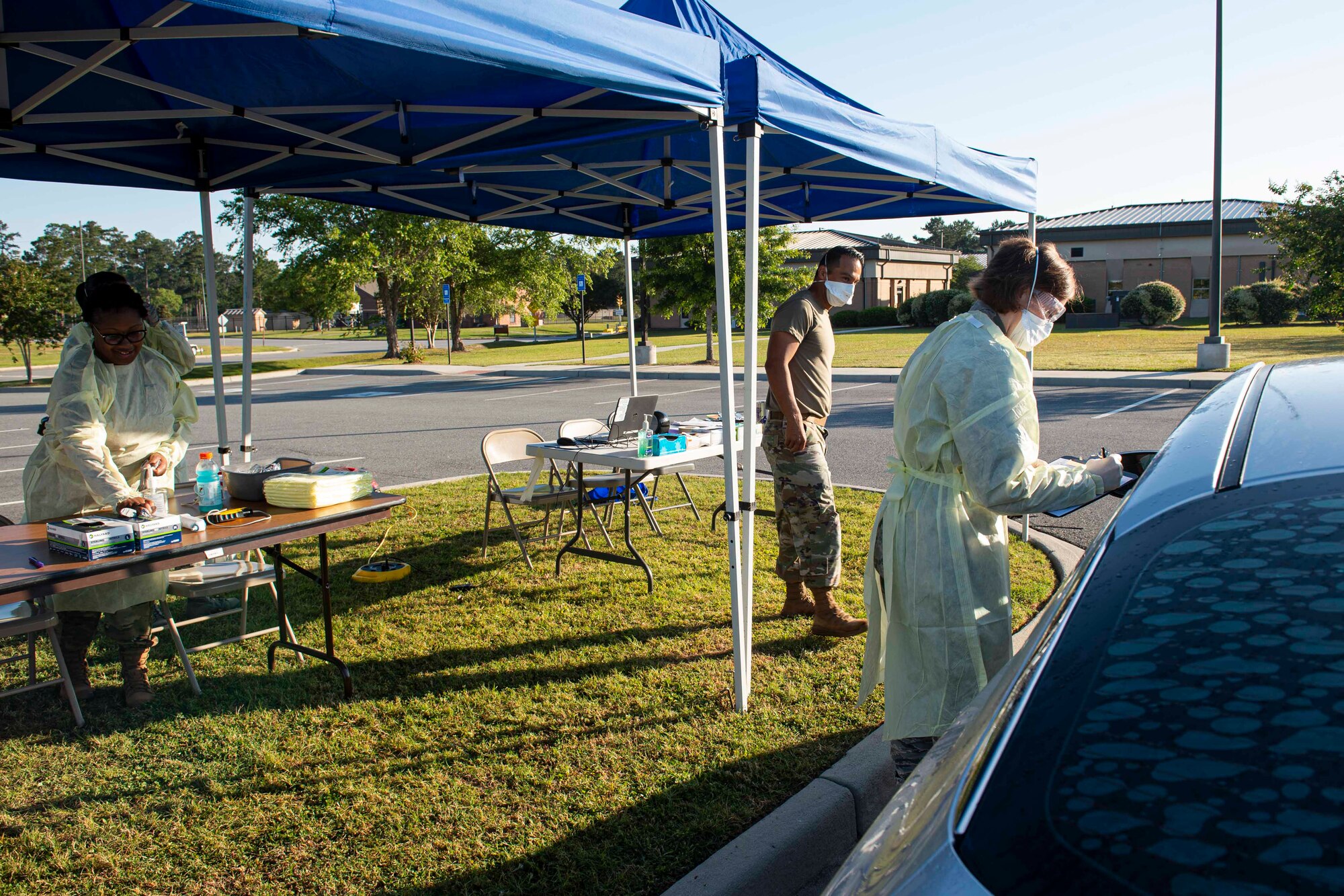 Photo of an Airman asking a patient questions during a COVID-19 Tier 2 screening.