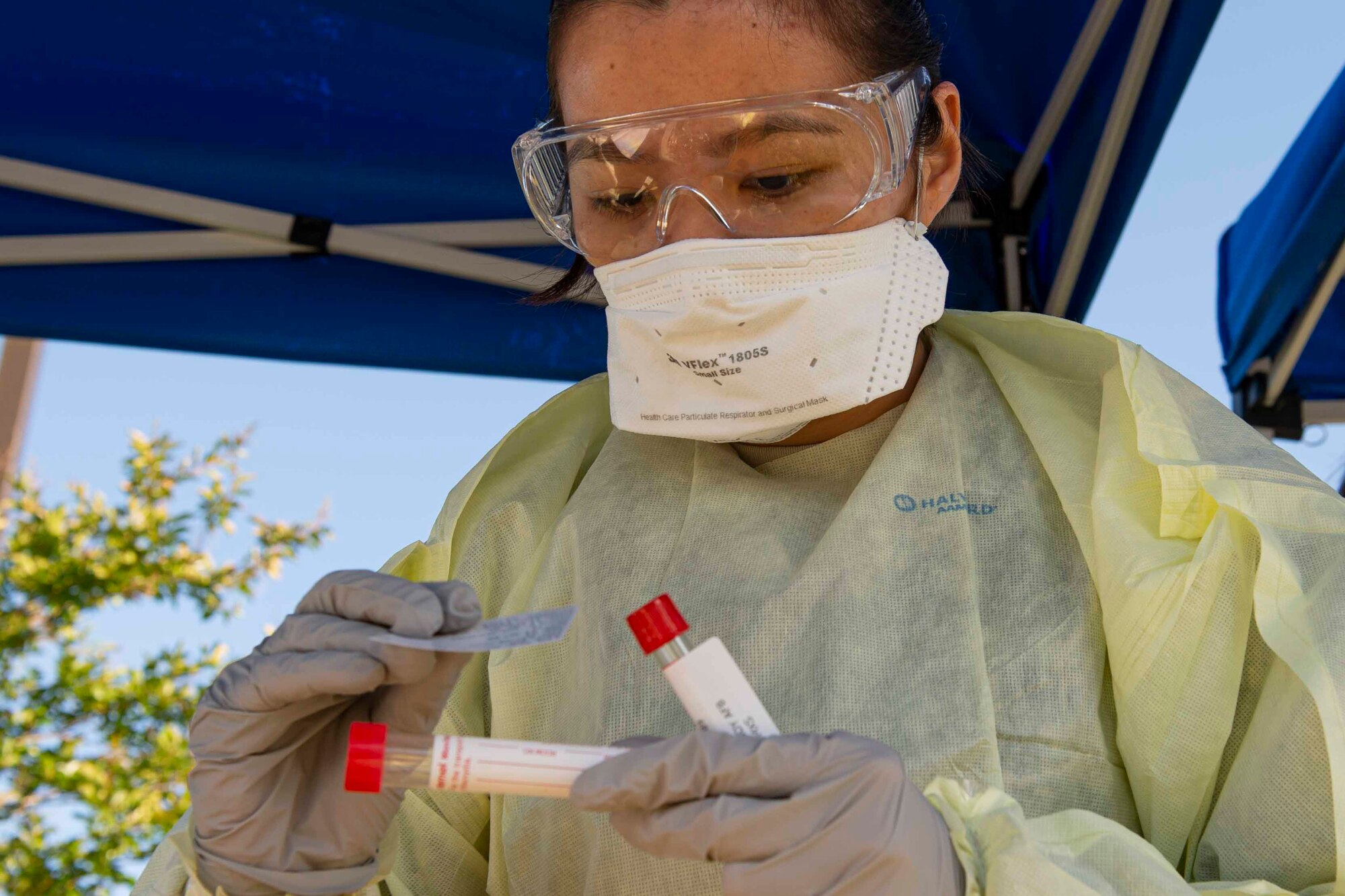 Photo of an Airmen labeling a nasal swab during a COVID-19 Tier 2 screening.