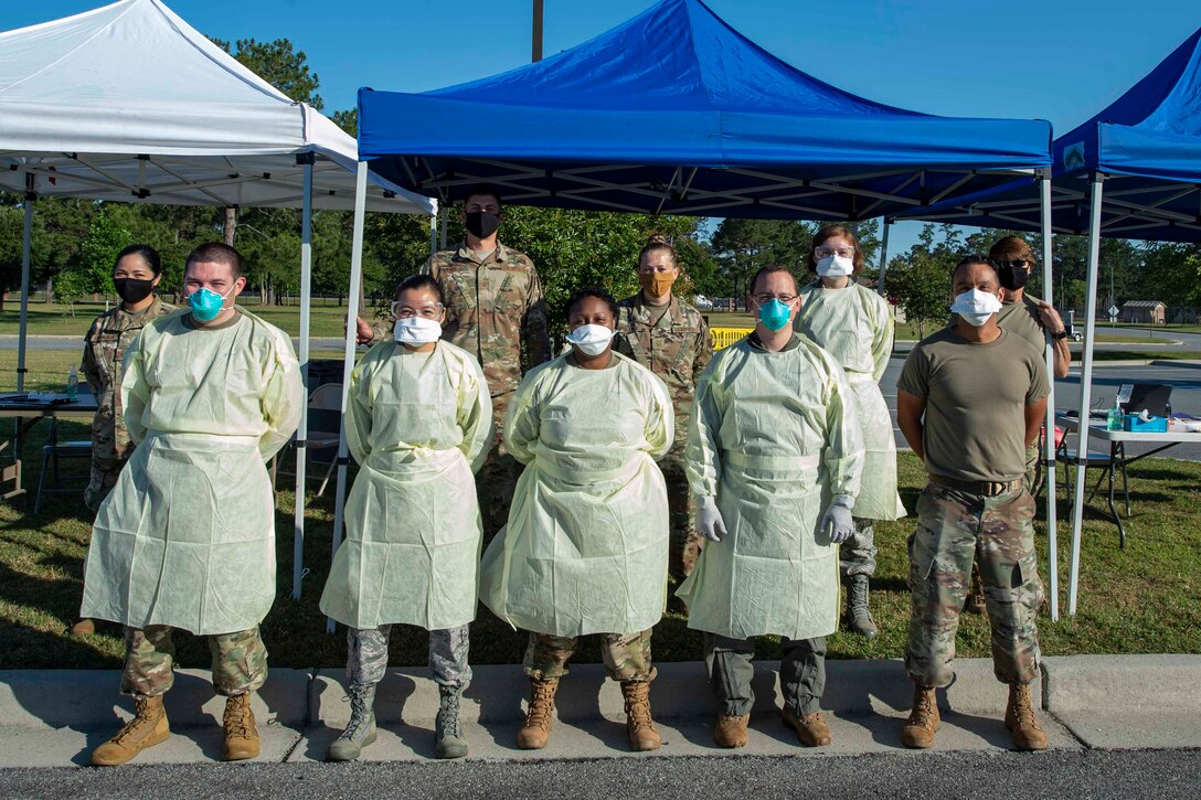 Photo of Airmen posing for a photo during a COVID-19 Tier 2 screening.