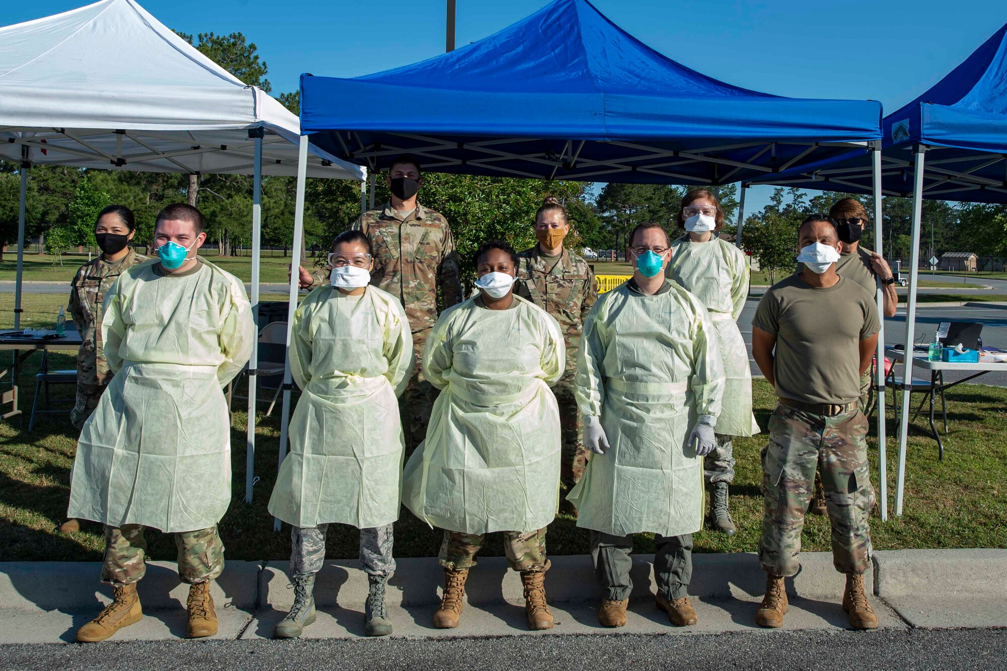 Photo of Airmen posing for a photo during a COVID-19 Tier 2 screening.