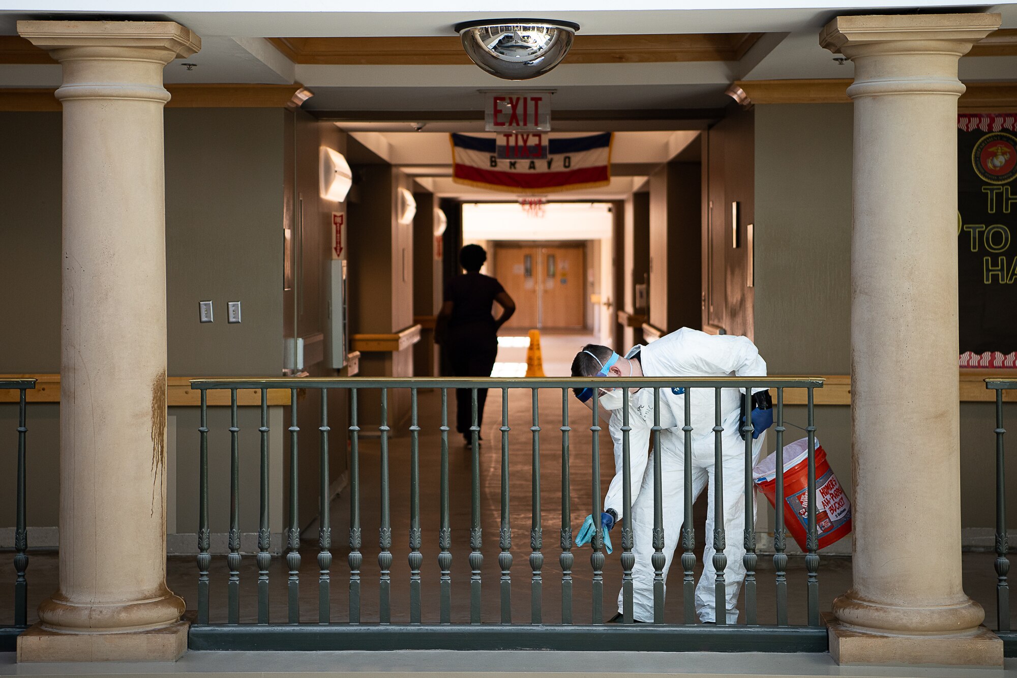 An Oklahoma Army National Guardsman uses Centers for Disease Control and Prevention-approved methods to disinfect the railing around an open stairwell of the Norman Veterans Center in Norman, Oklahoma, April 29, 2020. Guardsmen were at the Center to disinfect commonly touched surfaces and high traffic areas including handrails, chair arms, tables, switches and elevator buttons, split up into three teams, in order to more efficiently covering all of the common areas of the 275,000 square-foot facility. Using pressure sprayers and hand sprayers, the teams worked from the back of the facility to the front. The residents’ military service spans from World War II to Operation Desert Storm. (U.S. Air National Guard photo by Tech. Sgt. Kasey M. Phipps)