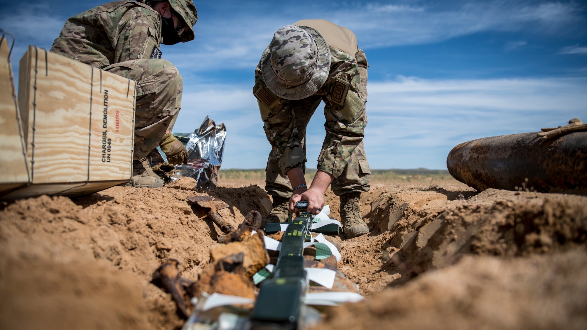 Members of the Explosive Ordnance Disposal unit, 812th Civil Engineer Squadron, 412th Test Wing, prepare unexploded ordnance and training munitions for demolition at the Precision Impact Range Area at Edwards Air Force Base, California, May 7. The 412th Test Wing uses the PIRA to conduct weapons and payload drops for flight tests. (Air Force photo by Giancarlo Casem)