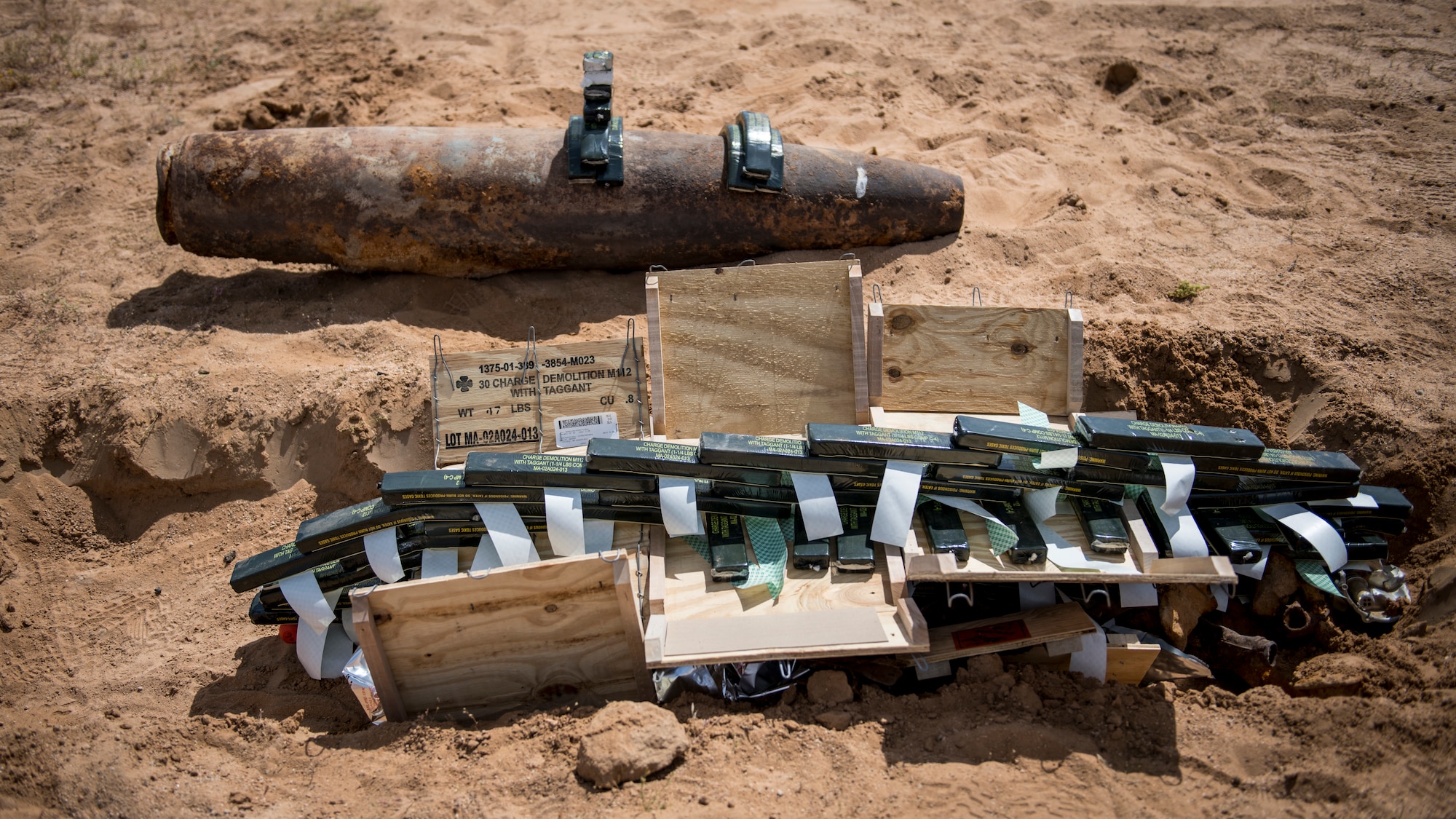 Members of the Explosive Ordnance Disposal unit, 812th Civil Engineer Squadron, 412th Test Wing, prepare unexploded ordnance and training munitions for demolition at the Precision Impact Range Area at Edwards Air Force Base, California, May 7. The 412th Test Wing uses the PIRA to conduct weapons and payload drops for flight tests. (Air Force photo by Giancarlo Casem)