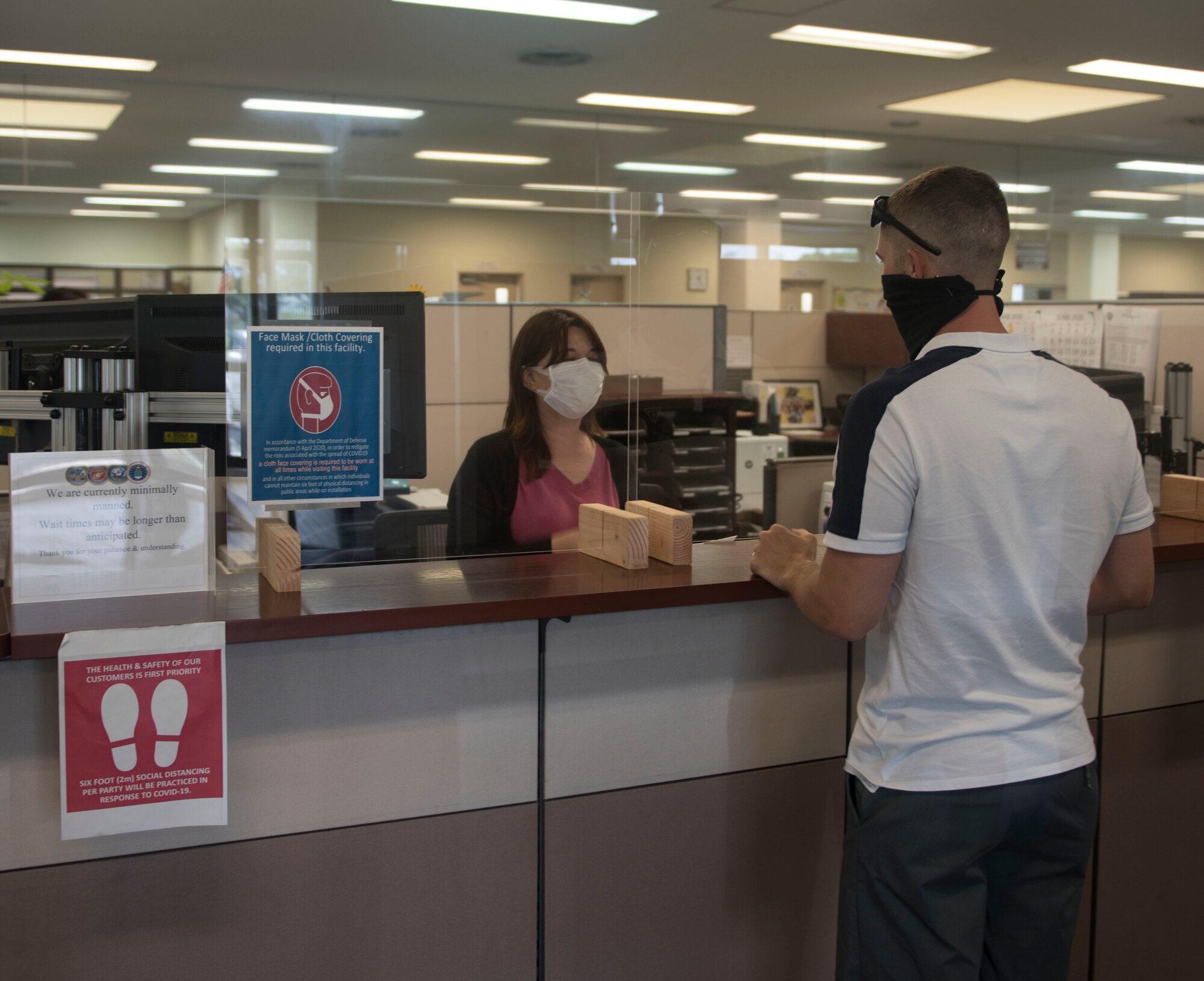 Housing office front desk employee and customer.