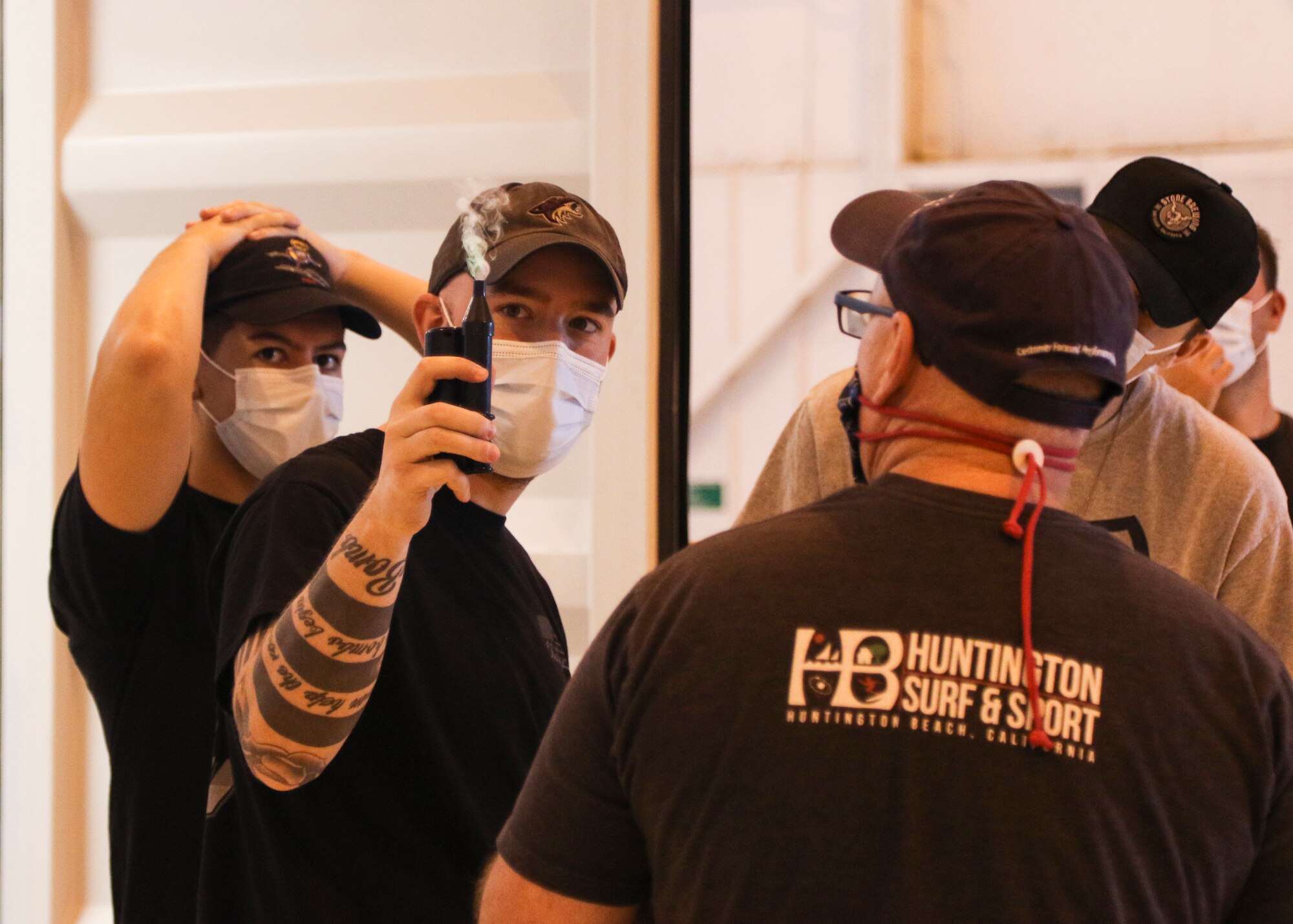 Christian Cook, a contractor with TRAX International, uses a handheld Smoke Pencil to test the Battelle Critical Care Decontamination System™for broken seals in Topeka, Kansas, May 3, 2020. The system can decontaminate used N95 respirator masks so they can be reused.