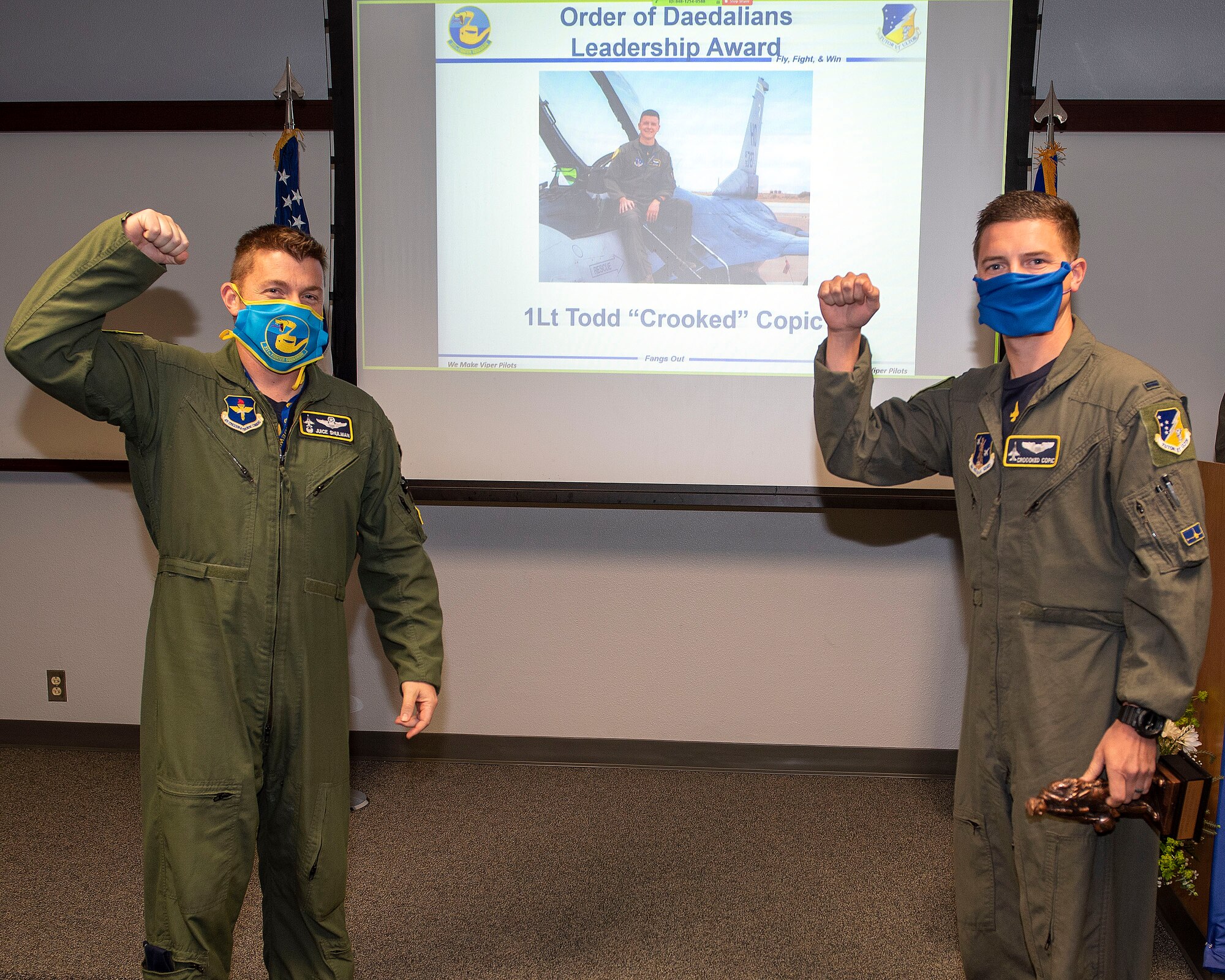 Lt. Col. Jeffrey Shulman, 311th Fighter Squadron commander, presents the Daedalian award to 1st Lt. Todd Copic, 311th FS Basic Course graduate, during the graduation of B-course Class 19-DBH, May 8, 2020, on Holloman Air Force Base, N.M. Twelve B-course students graduated and will be reassigned to operational flying units throughout the Combat Air Force. (U.S. Air Force photo by Staff Sgt. Christine Groening)