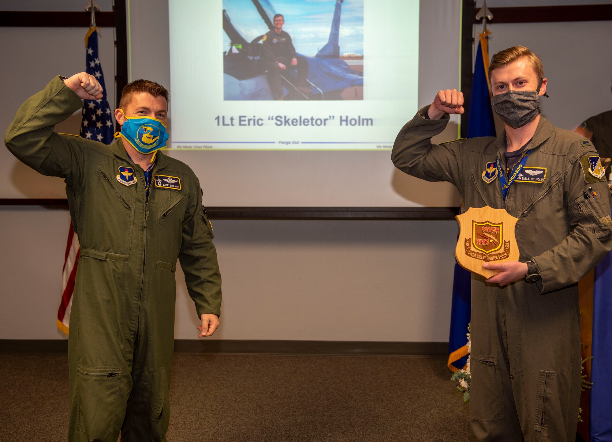 Lt. Col. Jeffrey Shulman, 311th Fighter Squadron commander, presents the River Rat award to 1st Lt. Eric Holm, 311th FS Basic Course graduate, during the graduation of B-course Class 19-DBH, May 8, 2020, on Holloman Air Force Base, N.M. Twelve B-course students graduated and will be reassigned to operational flying units throughout the Combat Air Force. (U.S. Air Force photo by Staff Sgt. Christine Groening)