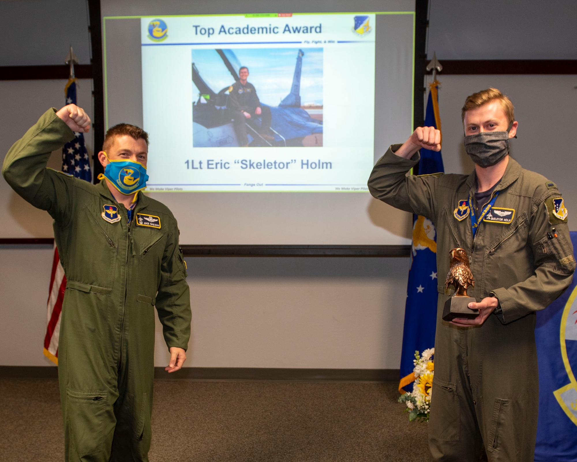 Lt. Col. Jeffrey Shulman, 311th Fighter Squadron commander, presents the Academic Award to 1st Lt. Eric Holm, 311th FS Basic Course graduate, during the graduation of B-course Class 19-DBH, May 8, 2020, on Holloman Air Force Base, N.M. Twelve B-Course students graduated and will be reassigned to operational flying units throughout the combat Air Force. (U.S. Air Force photo by Staff Sgt. Christine Groening)