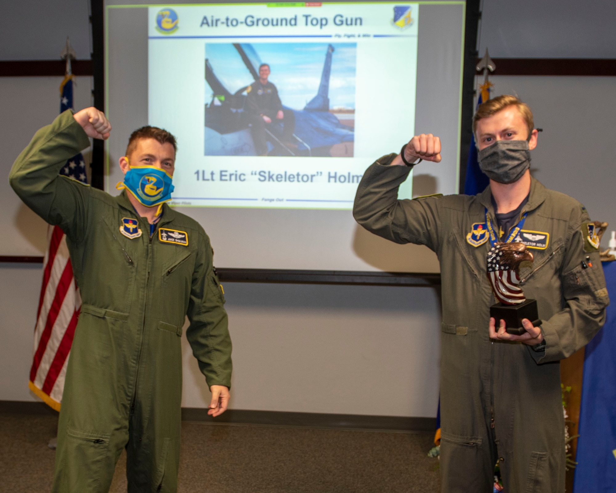 Lt. Col. Jeffrey Shulman, 311th Fighter Squadron commander, presents the Air-to-Ground award to 1st Lt. Eric Holm, 311th Fighter Squadron Basic Course graduate, during the graduation of B-course Class 19-DBH, May 8, 2020, on Holloman Air Force Base, N.M. Twelve B-course students graduated and will be reassigned to operational flying units throughout the Combat Air Force. (U.S. Air Force photo by Staff Sgt. Christine Groening)