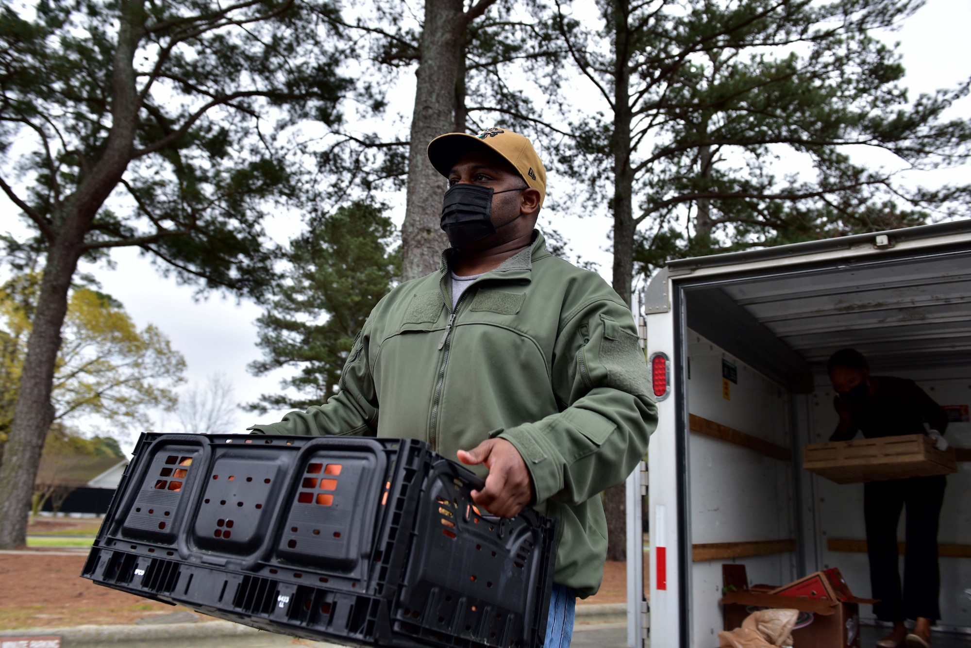 Tech. Sgt. Kevin Simon, 911th Air Refueling Squadron Non-commissioned Officer in Charge of readiness and training, carries produce during a bi-monthly produce run at Seymour Johnson Air Force Base, N.C. on March 22, 2020.