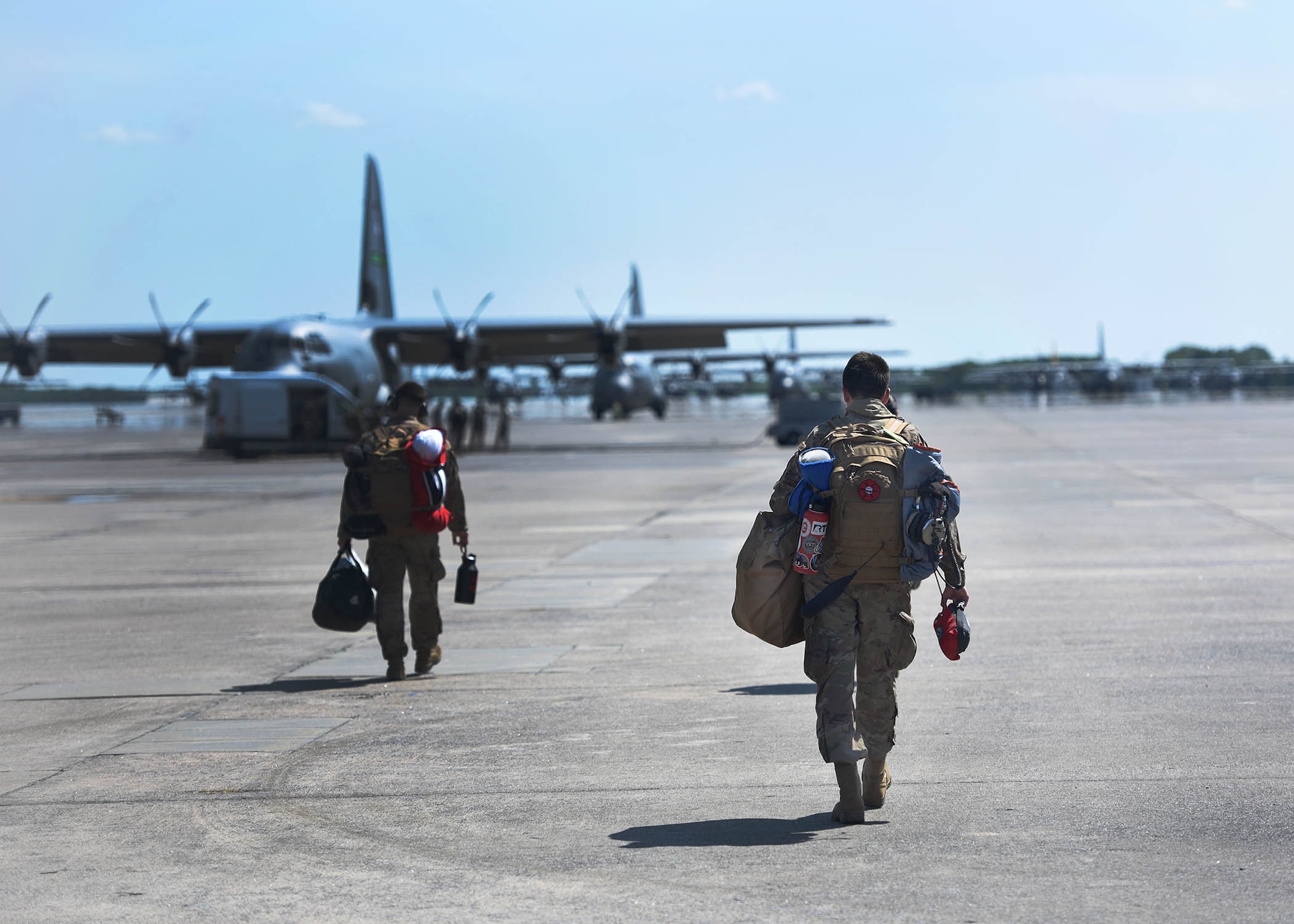 Airmen sit on the ramp of an aircraft before take off