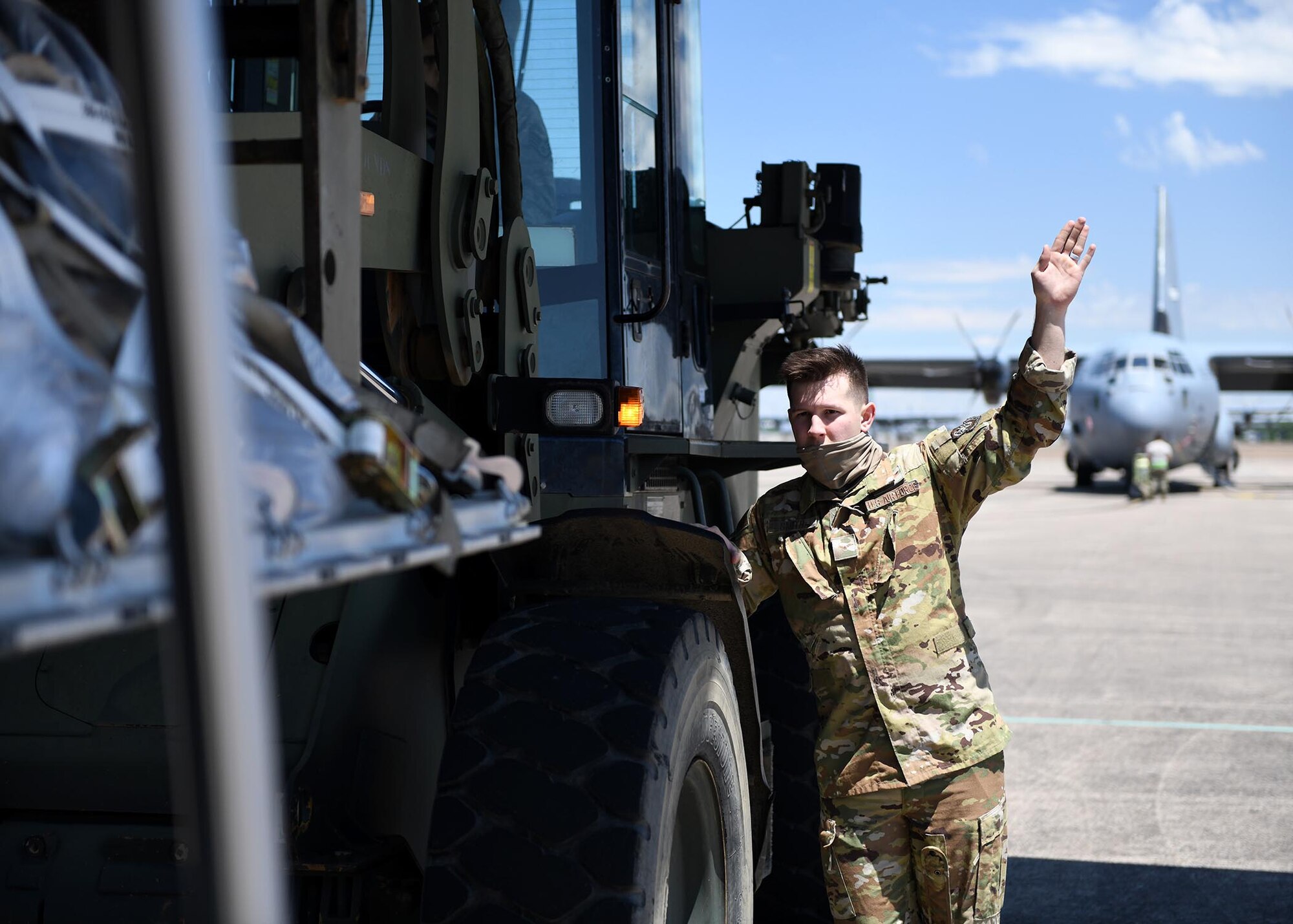 Airmen sit on the ramp of an aircraft before take off