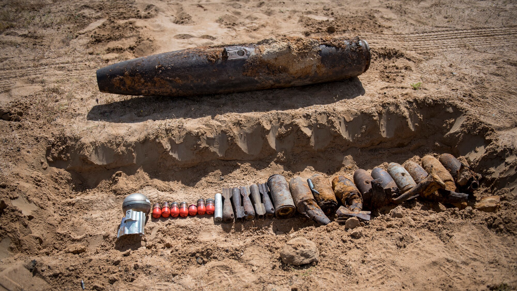 Members of the Explosive Ordnance Disposal unit, 812th Civil Engineer Squadron, 412th Test Wing, prepare unexploded ordnance and training munitions for demolition at the Precision Impact Range Area at Edwards Air Force Base, California, May 7. The 412th Test Wing uses the PIRA to conduct weapons and payload drops for flight tests. (Air Force photo by Giancarlo Casem)