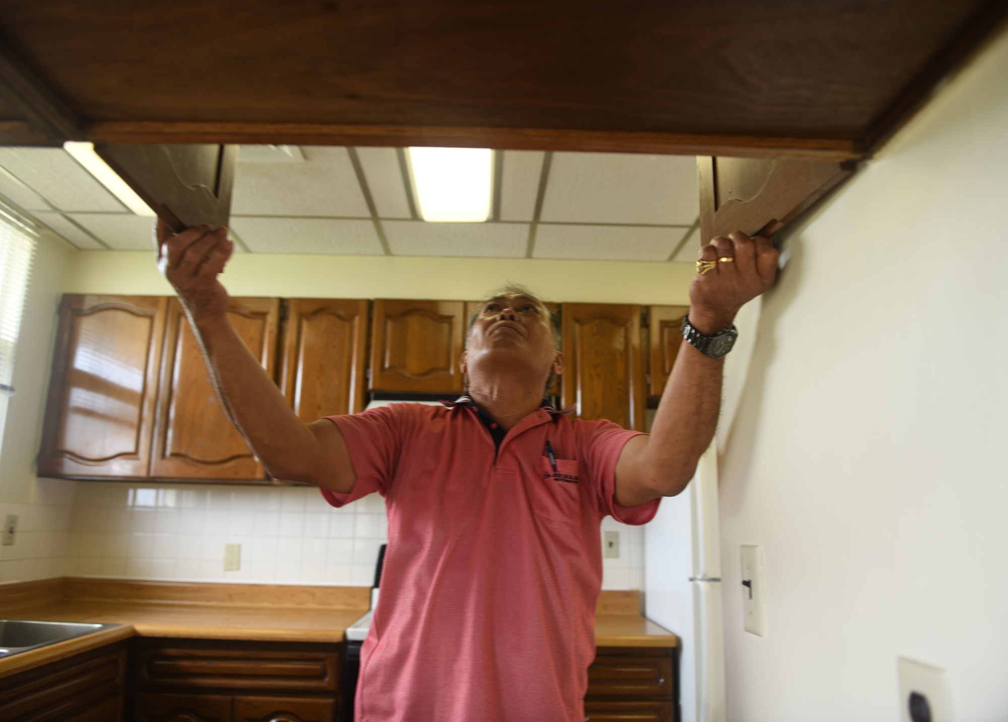 Housing inspector checking kitchen.