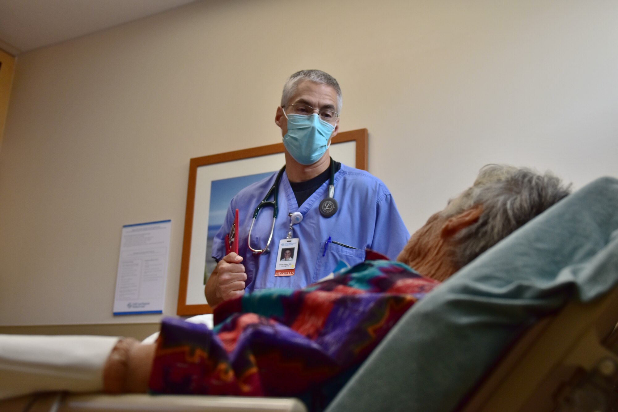 Doctor visits with patient at hospital room