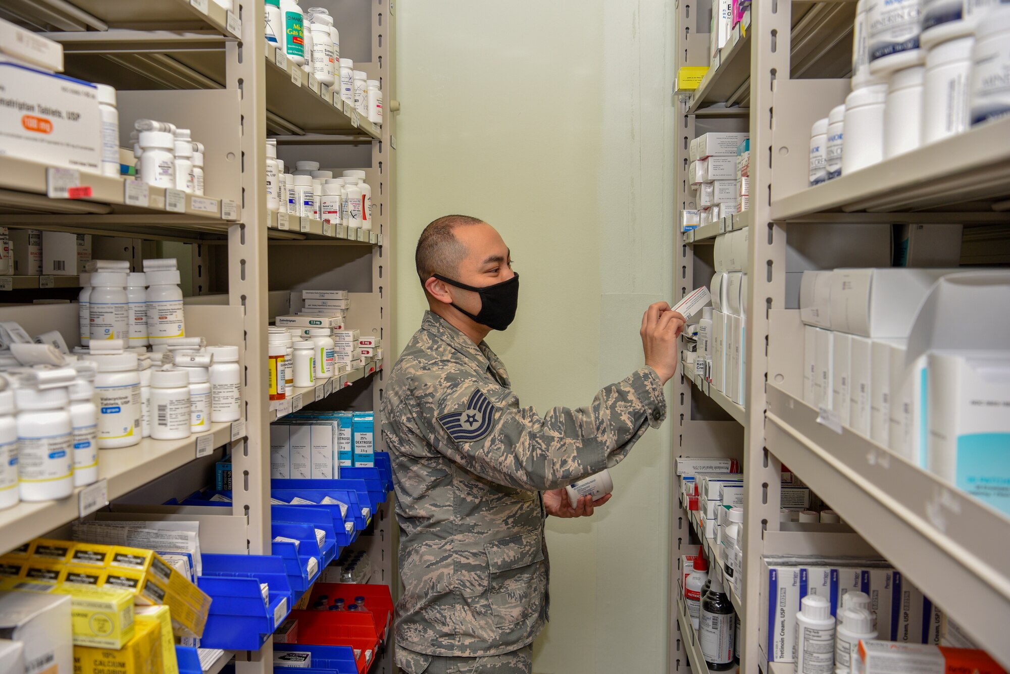 U.S. Air Force Tech. Sgt. Tyrone Rocha, 8th Medical Support Squadron NCO in charge of pharmaceutical services, checks inventory at Kunsan Air Base, Republic of Korea, May 6, 2020. The pharmacy team provides medical support to more than 2,500 members of the Wolf Pack to keep them fit to fight. (U.S. Air Force photo by Tech. Sgt. Joshua Arends)