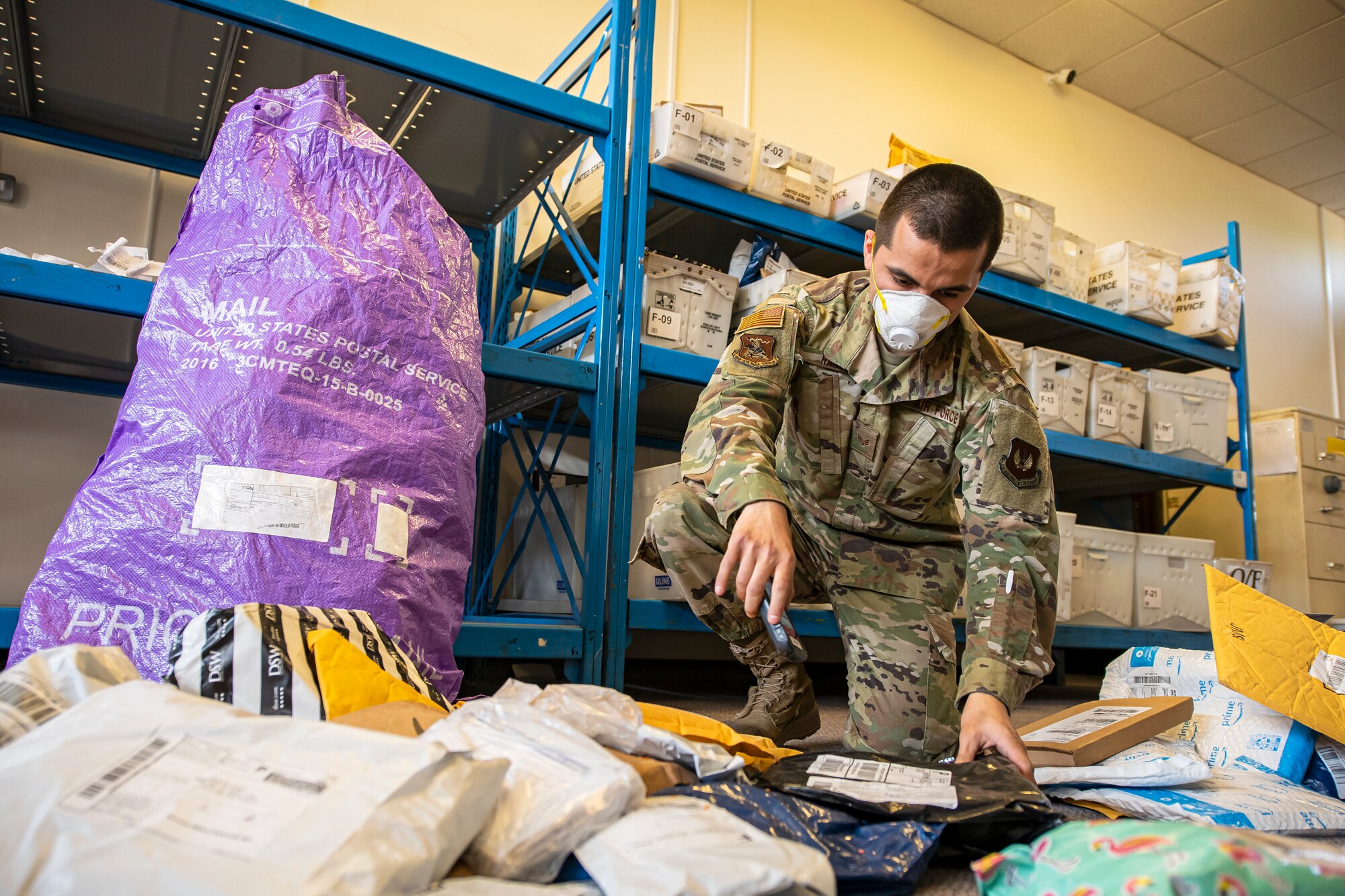 Senior Airman Daniel Rangel, 423d Force Support Squadron postal clerk, scans in packages, at RAF Alconbury, England on May 7, 2020.The 423d FSS postal team has continued to maintain operational readiness during COVID-19 as part of the central postal distribution hub for U.S. service members and their families stationed in the United Kingdom. (U.S. Air Force photo by Senior Airman Eugene Oliver)