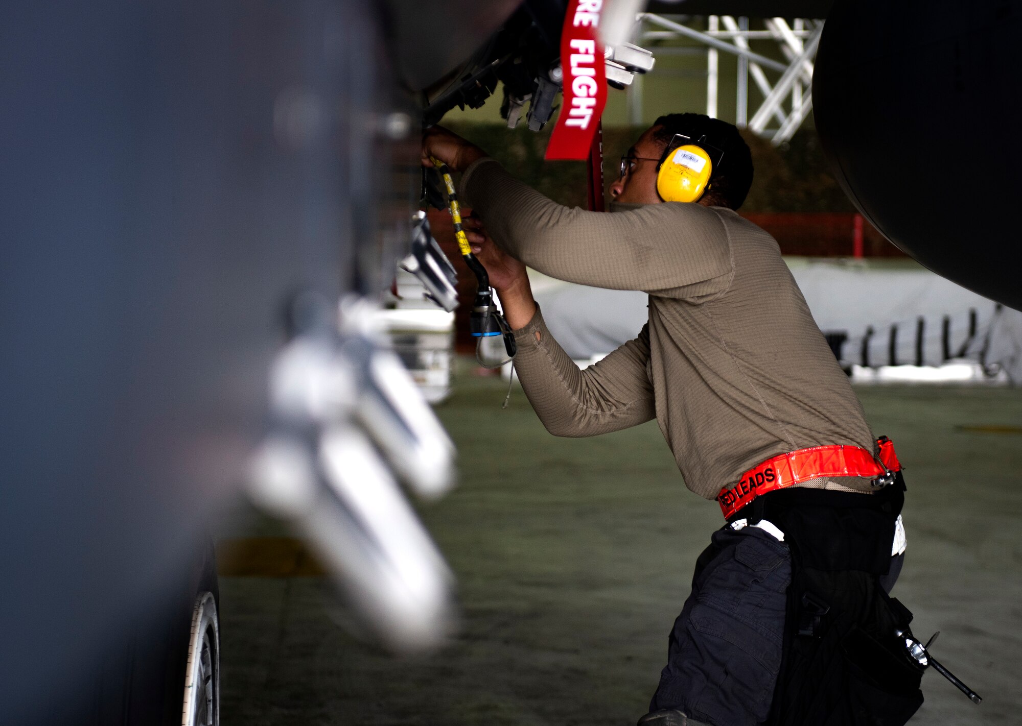 A weapons load crew member assigned to the 492nd Fighter Squadron Aircraft Maintenance Unit prepares to load munitions on an F-15E Strike Eagle at Royal Air Force Lakenheath, England, April 29, 2020. Liberty Wing AMU Airmen contributed to the 48th Maintenance Group earning the 2019 USAFE-AFAFRICA Clements McMullen Memorial Daedalian Weapon System Maintenance Trophy. (U.S. Air Force photo by Airman 1st Class Madeline Herzog)