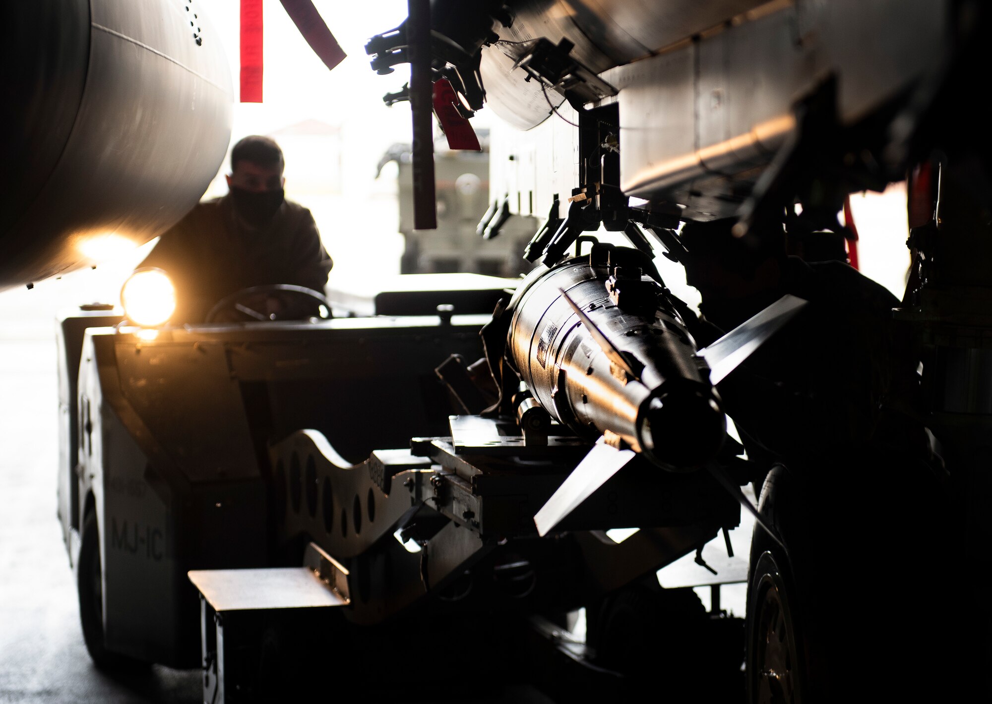 A weapons load crew member assigned to the 492nd Fighter Squadron Aircraft Maintenance Unit loads munitions onto an F-15E Strike Eagle at Royal Air Force Lakenheath, England, April 29, 2020. Liberty Wing weapons loaders helped the 48th Maintenance Group earn the 2019 USAFE-AFAFRICA Clements McMullen Memorial Daedalian Weapon System Maintenance Trophy for a third consecutive year. (U.S. Air Force photo by Airman 1st Class Madeline Herzog)