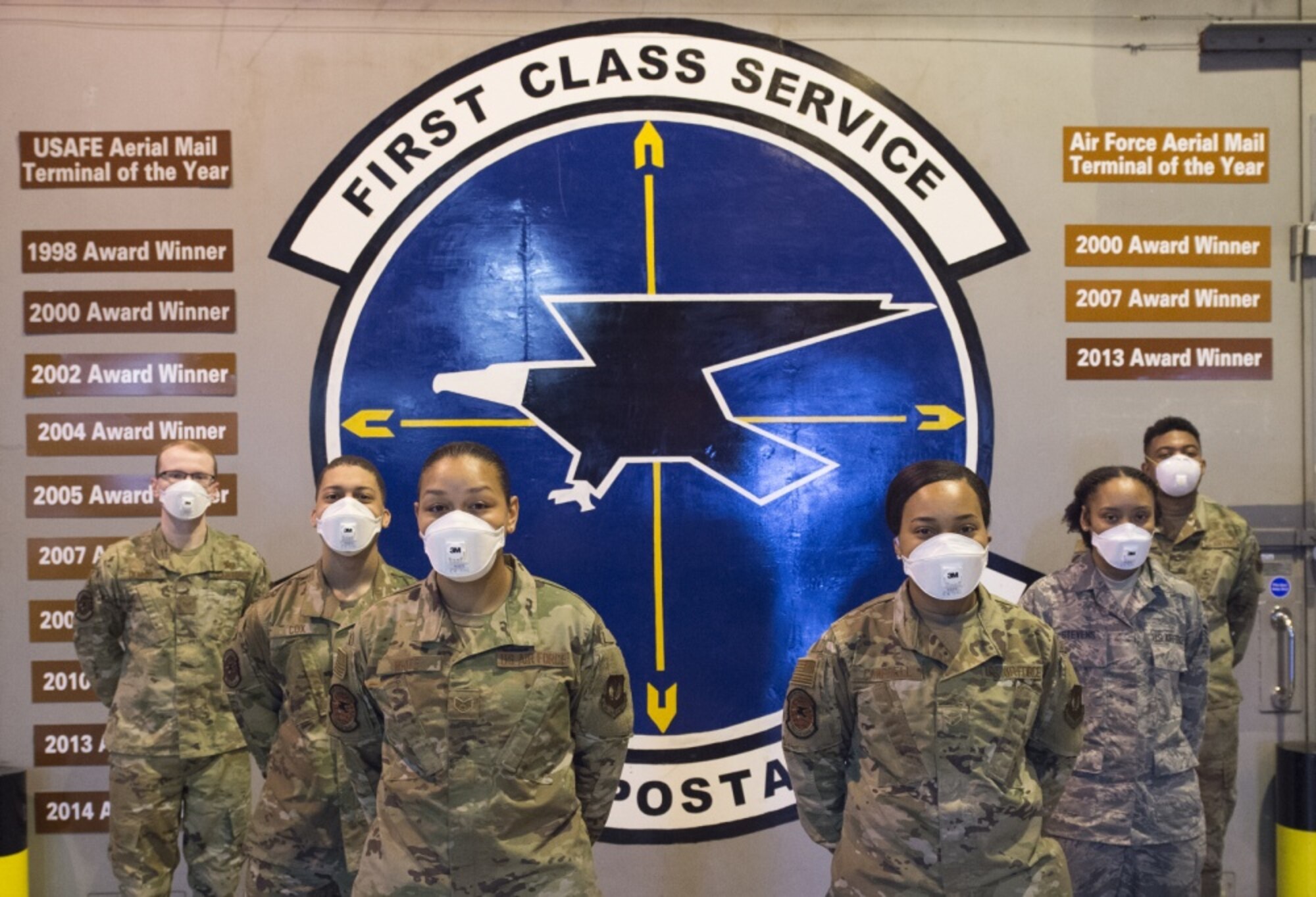 U.S. Air Force Airmen, with the USAFE-AFAFRICA Air Postal Squadron, Detachment Five, prepare packages for transportation from RAF Alconbury, England on April 10, 2020. The Detachment Five postal team continue to maintain operational readiness during COVID 19 as the central postal distribution hub for U.S. service members stationed in the United Kingdom. (U.S. Air Force photo by Master Sgt. Brian Kimball)