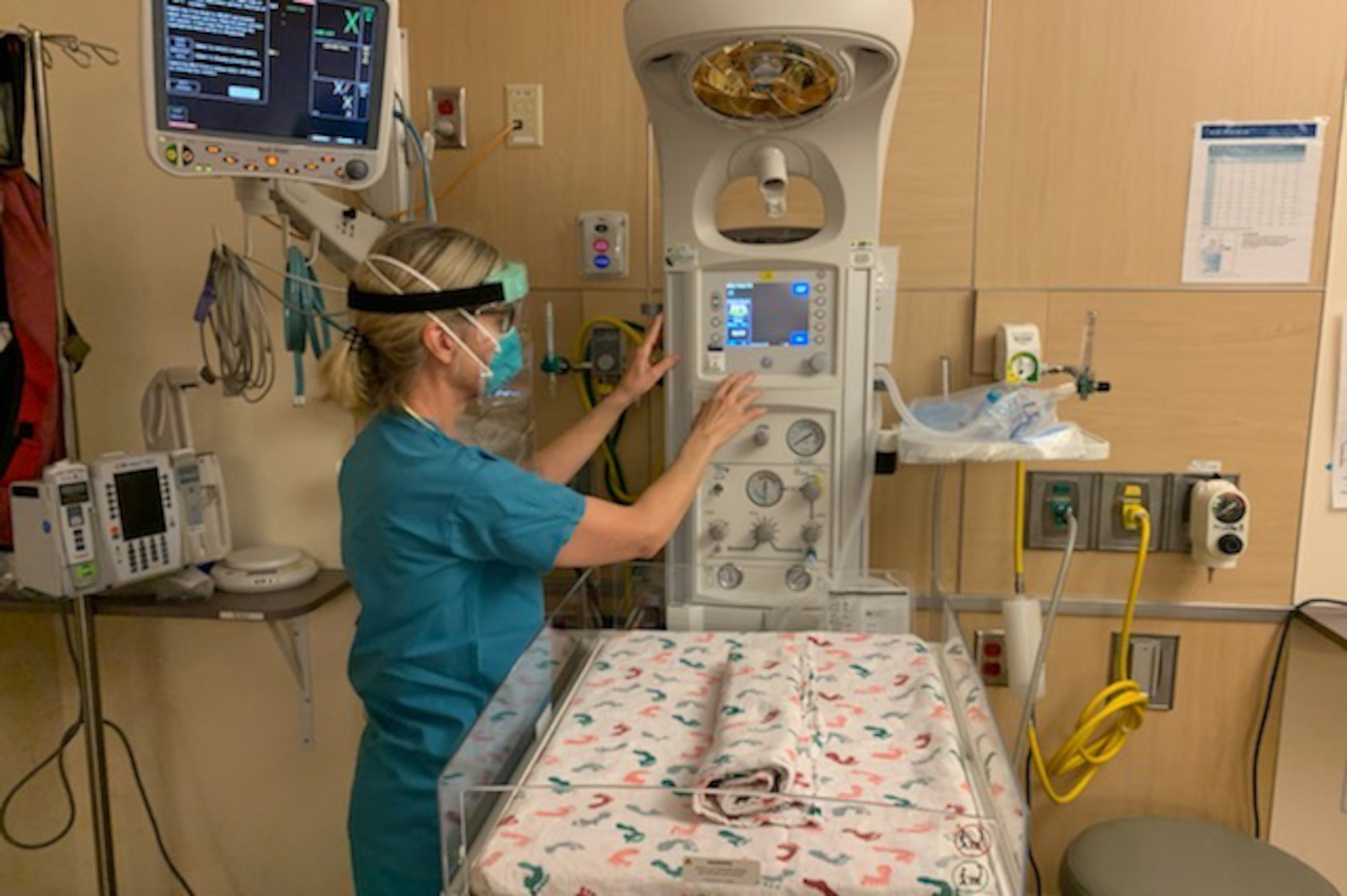 Julia Kitterman, a Neonatal Intensive Care Unit nurse at St. Peters Hospital in Olympia, Wa., prepares a work station during her shift May 11, 2020. The NICU is respoinsible for newborn babies that have certain difficulties and need extra care before they can go home. (U.S. Air Force photo by Staff Sgt. Luke Kitterman)