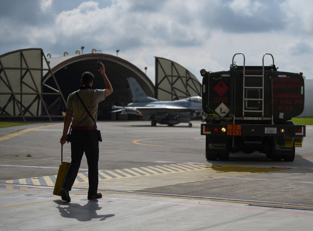 U.S. Air Force Airman 1st Class Corey Chalupa, 31st Aircraft Maintenance Squadron, 510th Aircraft Maintenance Unit crew chief, directs a fuel truck at Aviano Air Base, Italy, May 12, 2020. The 510th FS provided combat airpower on demand to U.S. and NATO combatant commanders as well as the National Command Authority in order to meet National Security objectives. (U.S. Air Force photo by Airman 1st Class Ericka A. Woolever)