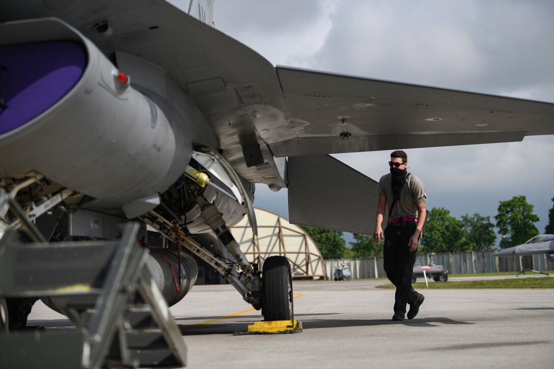U.S. Air Force Airman 1st Class Corey Chalupa, 31st Aircraft Maintenance Squadron, 510th Aircraft Maintenance Unit crew chief, performs a walk-through of an F-16 Fighting Falcon aircraft at Aviano Air Base, Italy, May 12, 2020. During 1993-1994, the 510th FS flew more than 1,700 combat sorties from Aviano AB, Italy, in support of Operation Deny Flight. (U.S. Air Force photo by Airman 1st Class Ericka A. Woolever)