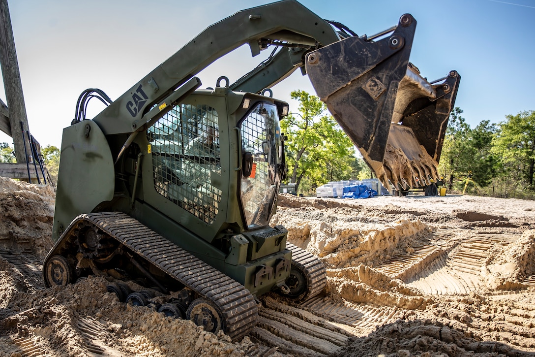 A U.S. Marine operates a skid steer during a command post exercise at Marine Corps Base Camp Lejeune, N.C., April 8.