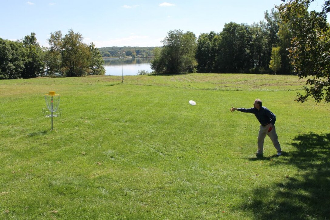 A recreator playing disc golf at Woodcock Lake Park.