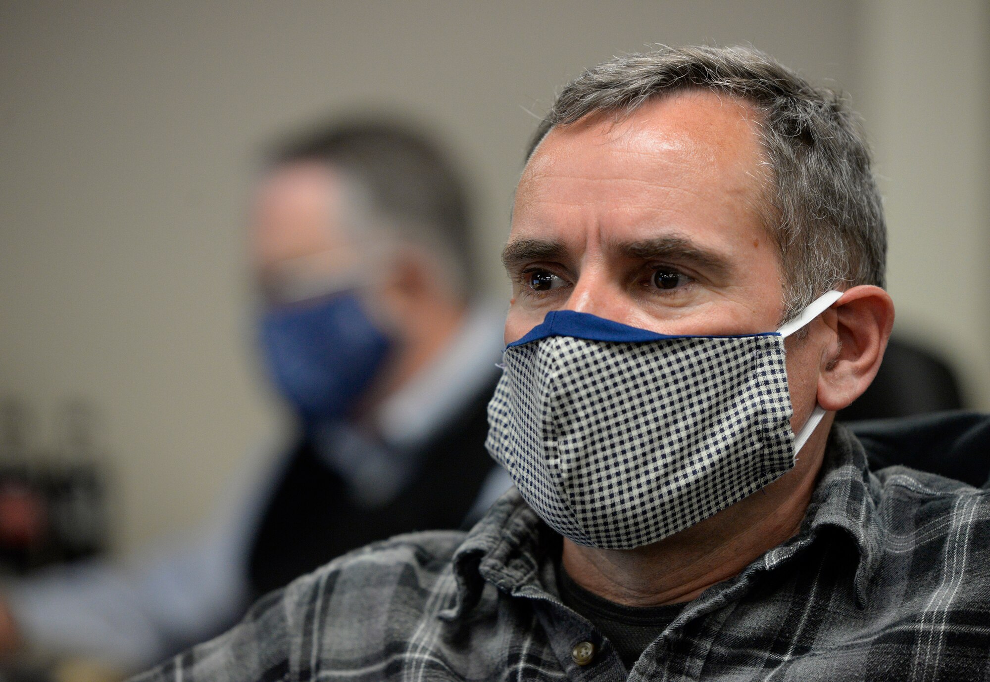William Neitzke, 88th Air Base Wing Incident Command Center director of safety and planning listens to a daily conference call with Col. Thomas P. Sherman, 88 ABW commander, while monitoring the COVID-19 pandemic at Wright-Patterson Air Force Base, Ohio, May 5, 2020. (U.S. Air Force photo/Ty Greenlees)