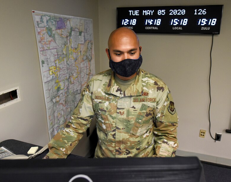 Tech. Sgt. Jeremy Ordiales, 88th Air Base Wing Incident Command Center section chief, admin cell, listens to a daily conference call with Col. Thomas P. Sherman, 88 ABW commander, while monitoring the COVID-19 pandemic at Wright-Patterson Air Force Base, Ohio, May 5, 2020. (U.S. Air Force photo/Ty Greenlees)