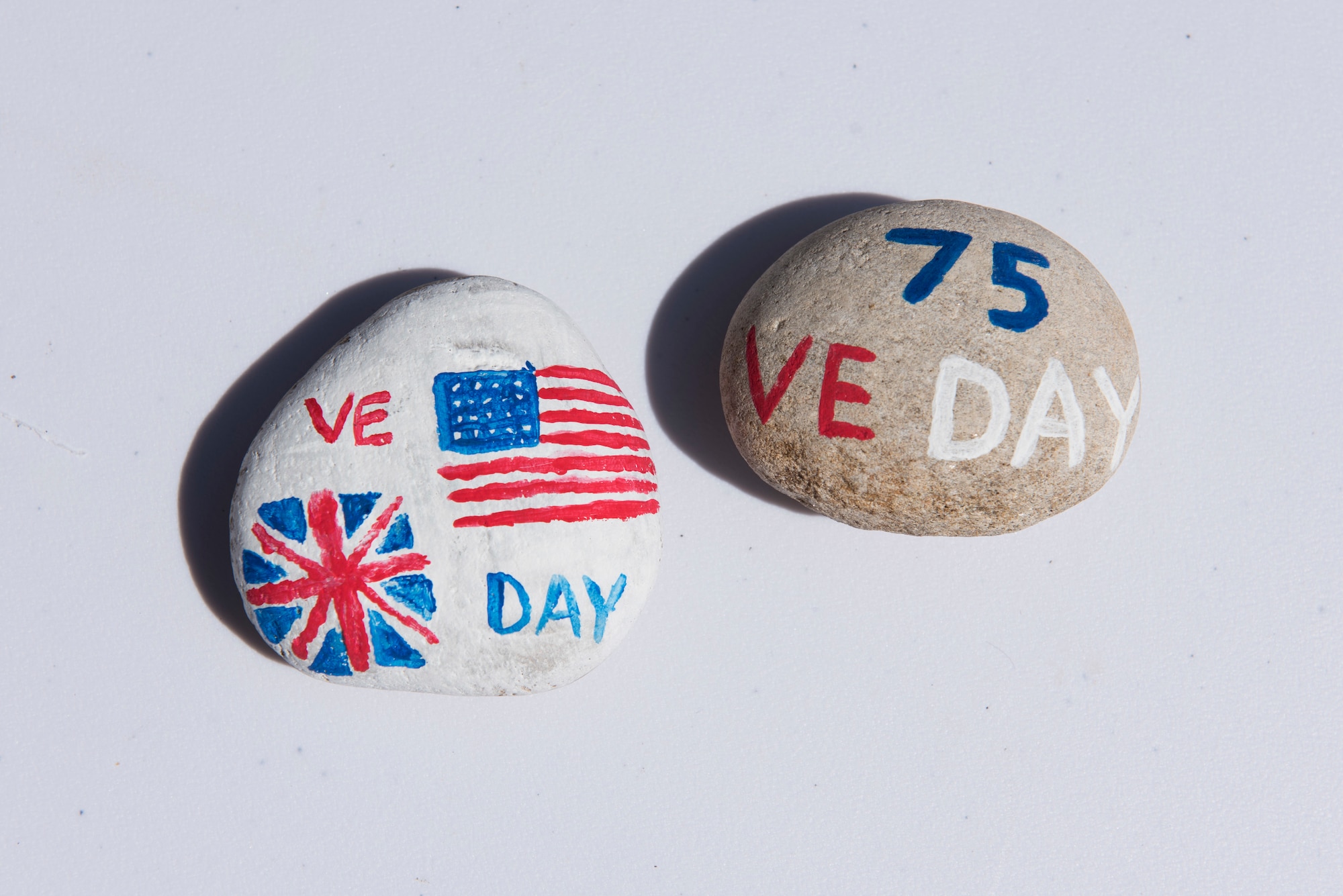 Victory in Europe Day painted rocks are placed at a World War II memorial during the V-E Day Scavenger Hunt at RAF Alconbury, England May 8, 2020. While keeping with COVID-19 physical distancing guidelines, the self-guided walking tour on base was geared toward teaching children and families the events that led to the end of World War II as they exercised. (U.S. Air Force photo by Airman 1st Class Jennifer Zima)