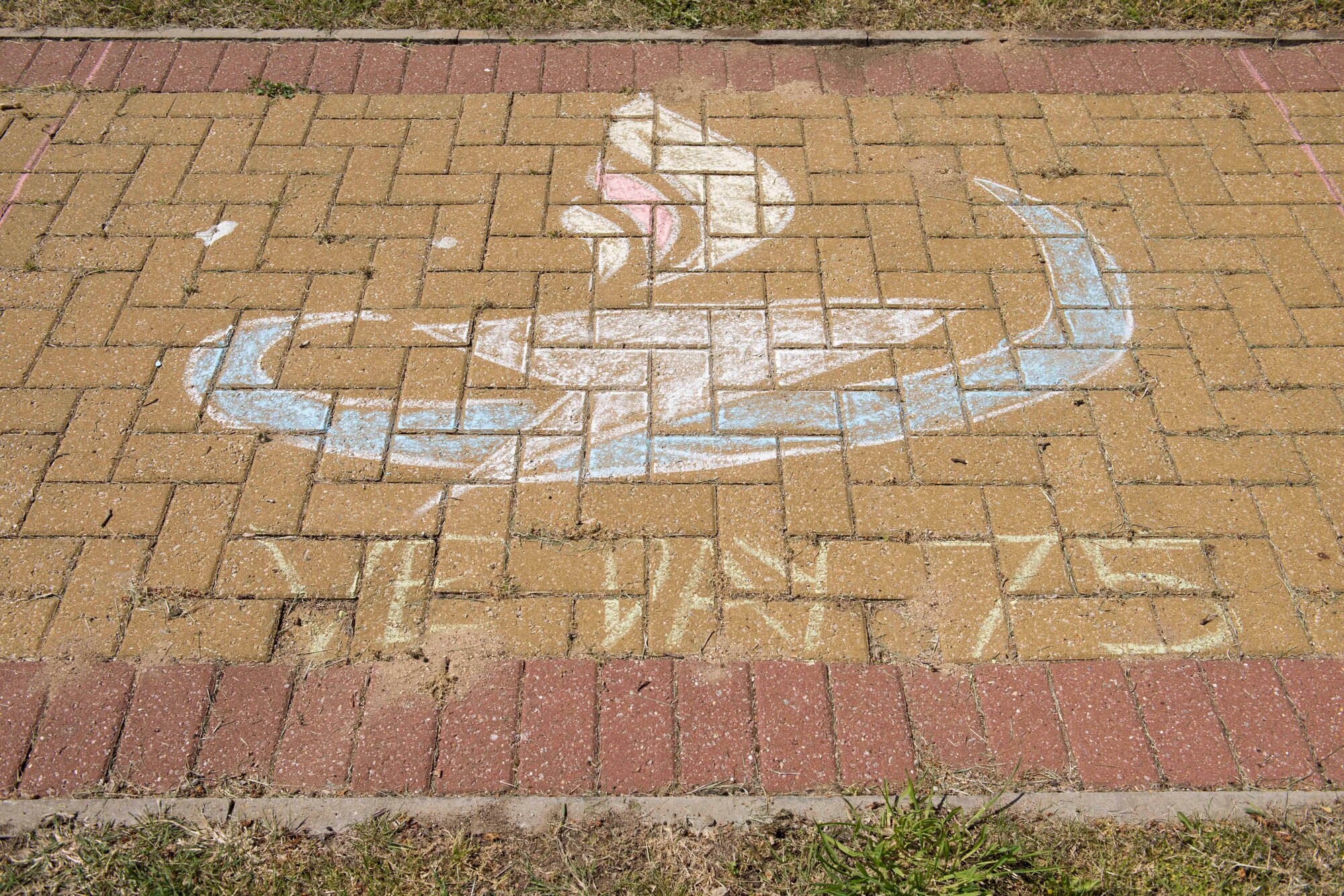 Victory in Europe Day sidewalk art is displayed during the V-E Day Scavenger Hunt at RAF Alconbury, England May 8, 2020. While keeping with COVID-19 physical distancing guidelines, the self-guided walking tour on base was geared toward teaching children and families the events that led to the end of World War II as they exercised. (U.S. Air Force photo by Airman 1st Class Jennifer Zima)