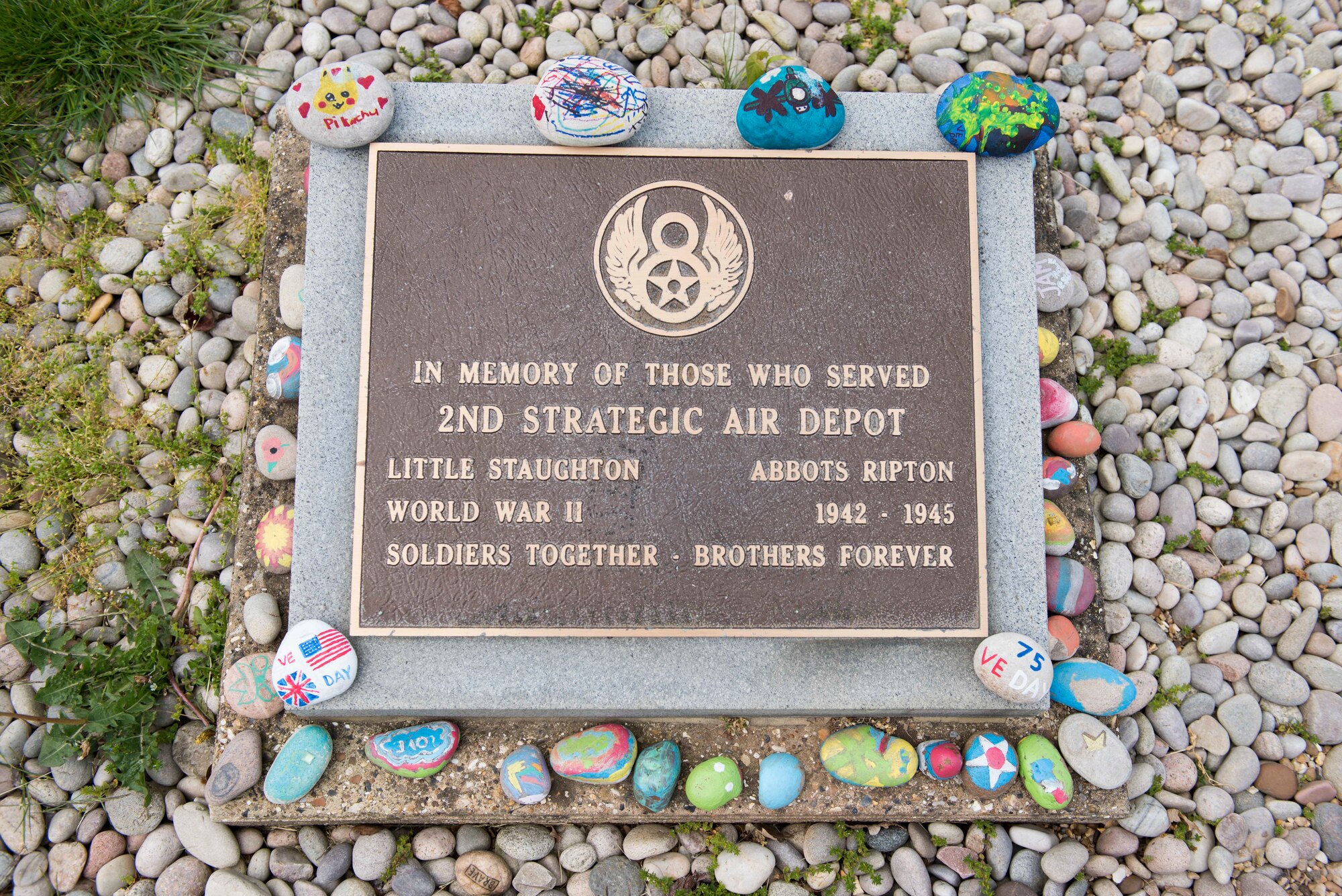 Victory in Europe Day painted rocks are placed at a World War II memorial during the V-E Day Scavenger Hunt at RAF Alconbury, England May 8, 2020. While keeping with COVID-19 physical distancing guidelines, the self-guided walking tour on base was geared toward teaching children and families the events that led to the end of World War II as they exercised. (U.S. Air Force photo by Airman 1st Class Jennifer Zima)