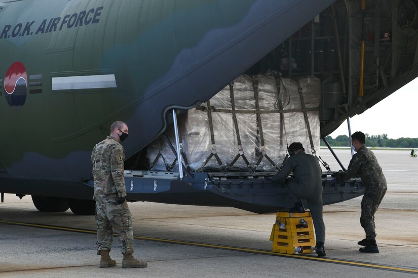 89th Airlift Wing Airmen and South Korean aircrew unload a Republic of Korea C-130 aircraft carrying protective masks at Joint Base Andrews, Md., May 12, 2020. The protective masks are being donated in honor of the 70th anniversary of the Korean War, which began on June 25, 1950 and ended on July 27, 1953. (U.S. Air Force photo by Airman 1st Class Spencer Slocum)
