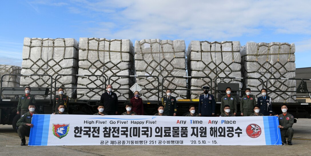 Air Force, Department of Veterans Affairs and South Korean leadership pose for a photo at Joint Base Andrews, Md., May 12, 2020. Officials from the Embassy of the Republic of Korea greeted the arriving Korean military aircrew when the C-130 aircraft landed on JBA. (U.S. Air Force photo by Airman 1st Class Spencer Slocum)