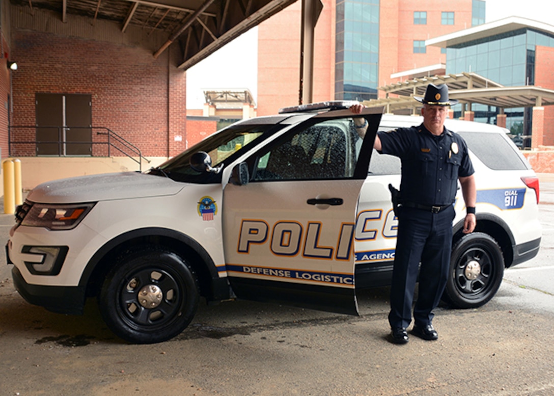 Lt. Mark Bowen stands by his police car