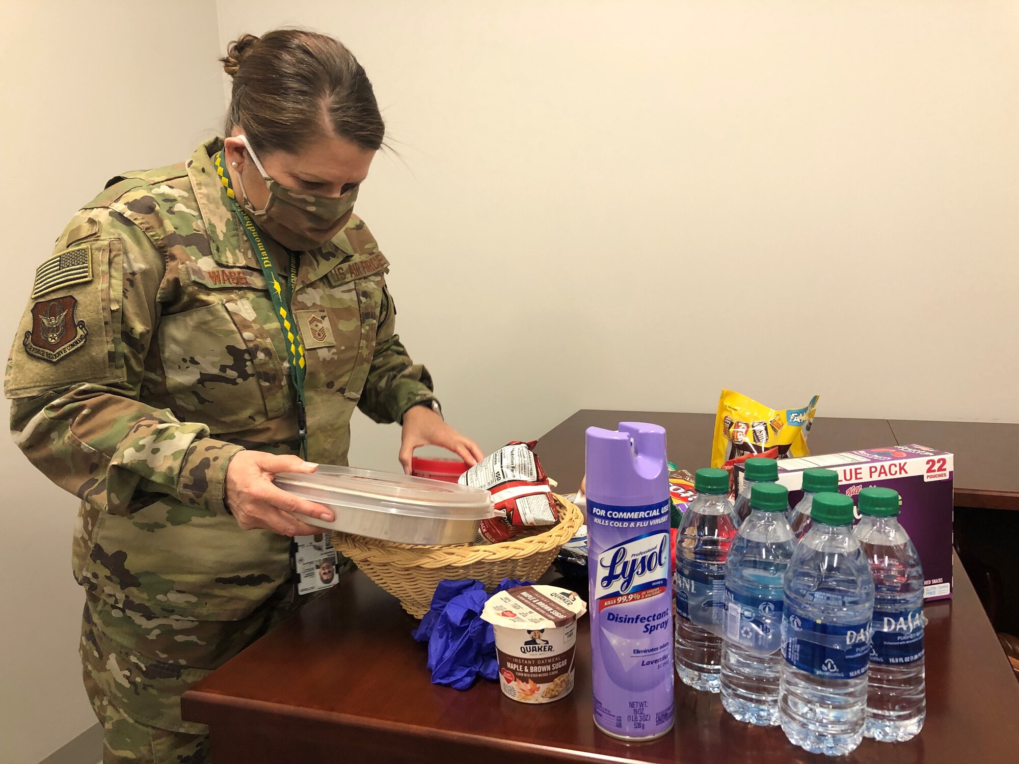 Senior Master Sgt. Tamara Wass, first sergeant for the 419th Aircraft Maintenance Squadron, builds one of several goody baskets for personnel who will self-quarantine on base after returning from deployment