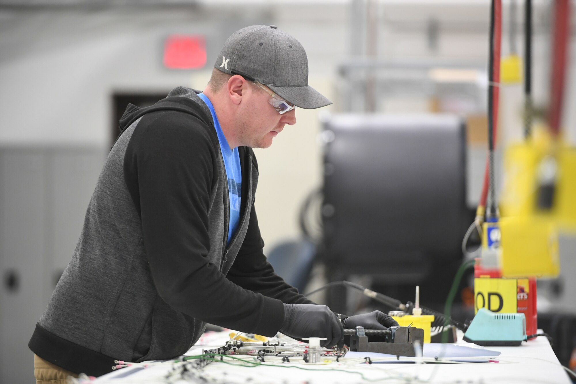 Sean Hamilton, 309th Electronics Maintenance Group, solders a wire harness from the B-809 ground power unit April 29, 2020, at Hill Air Force Base, Utah. The 309th EMXG in the Ogden Air Logistics Complex provides repair and overhaul for exchangeable assets for a multitude of systems on a wide assortment of Air Force weapons systems including fighter aircraft, intercontinental ballistic missiles, powered aerospace ground equipment, tactical shelters, as well as refurbishment of radomes worldwide. (U.S. Air Force photo by Cynthia Griggs)
